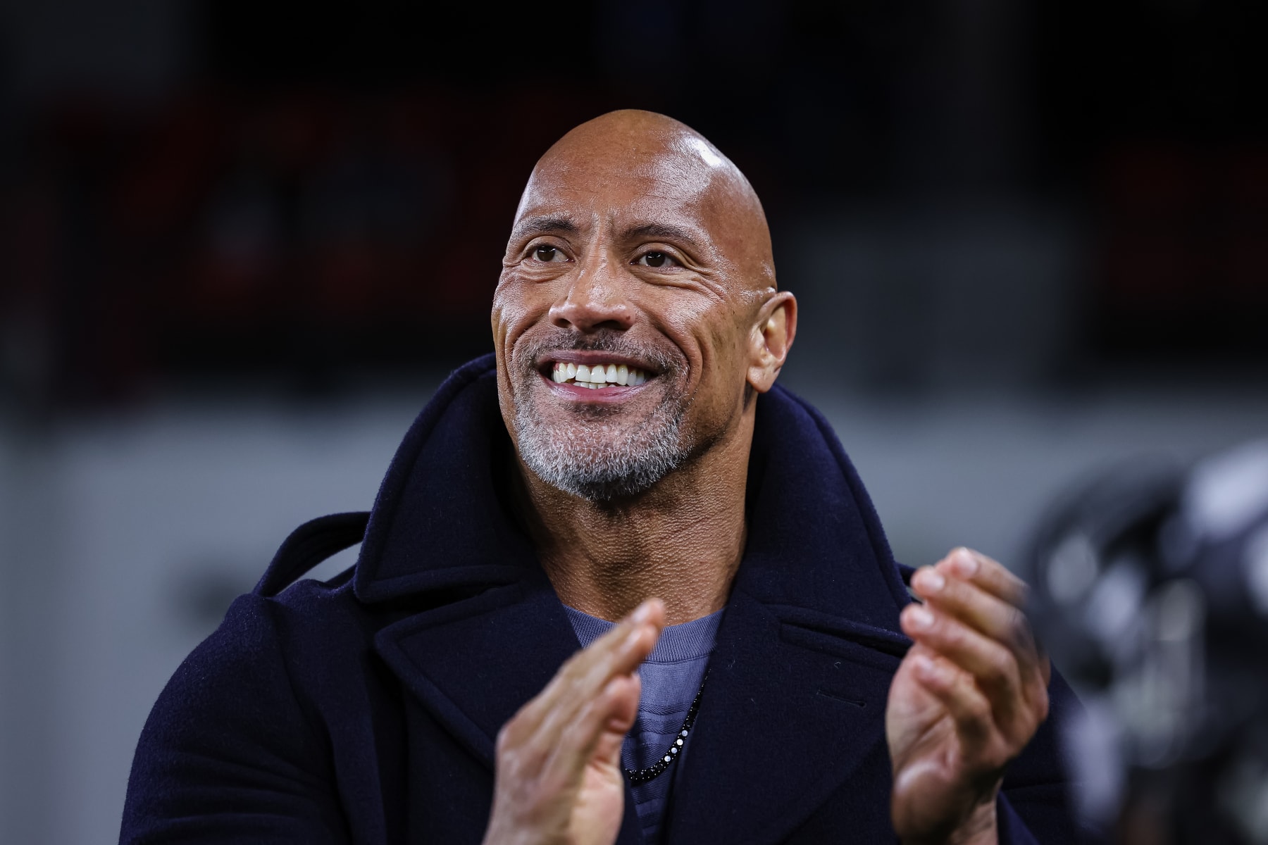 WASHINGTON, DC - FEBRUARY 19: (L-R) XFL owner Dwayne Johnson reacts on the sideline during the first half of the XFL game between the DC Defenders and the Seattle Sea Dragons at Audi Field on February 19, 2023 in Washington, DC. (Photo by Scott Taetsch/Getty Images)between the DC Defenders and the Seattle Sea Dragons