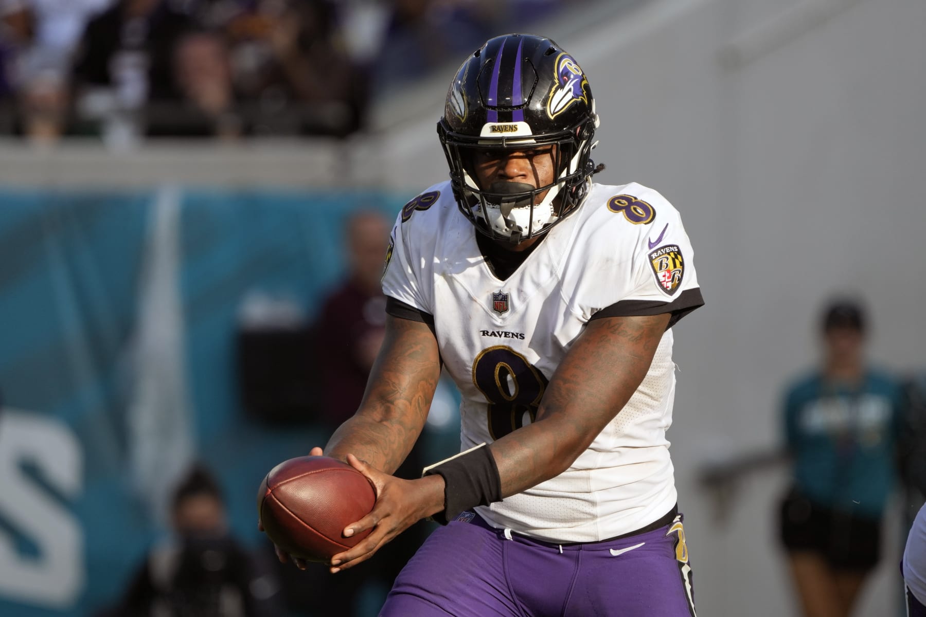 Baltimore Ravens quarterback Lamar Jackson (8) hands off the ball during the second half of an NFL football game against the Jacksonville Jaguars, Sunday, Nov. 27, 2022, in Jacksonville, Fla. (AP Photo/John Raoux)