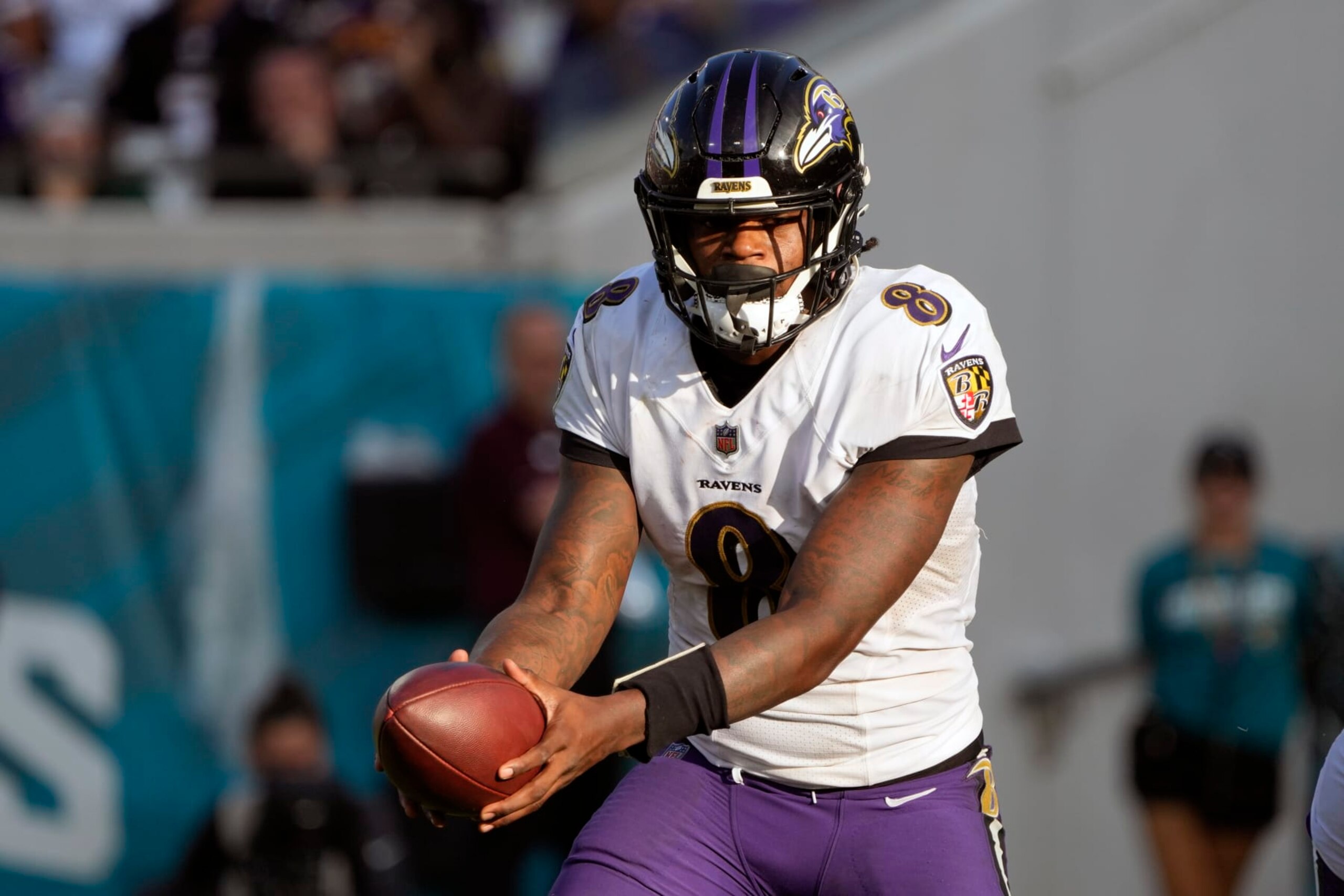 Baltimore Ravens quarterback Lamar Jackson (8) hands off the ball during the second half of an NFL football game against the Jacksonville Jaguars, Sunday, Nov. 27, 2022, in Jacksonville, Fla. (AP Photo/John Raoux)