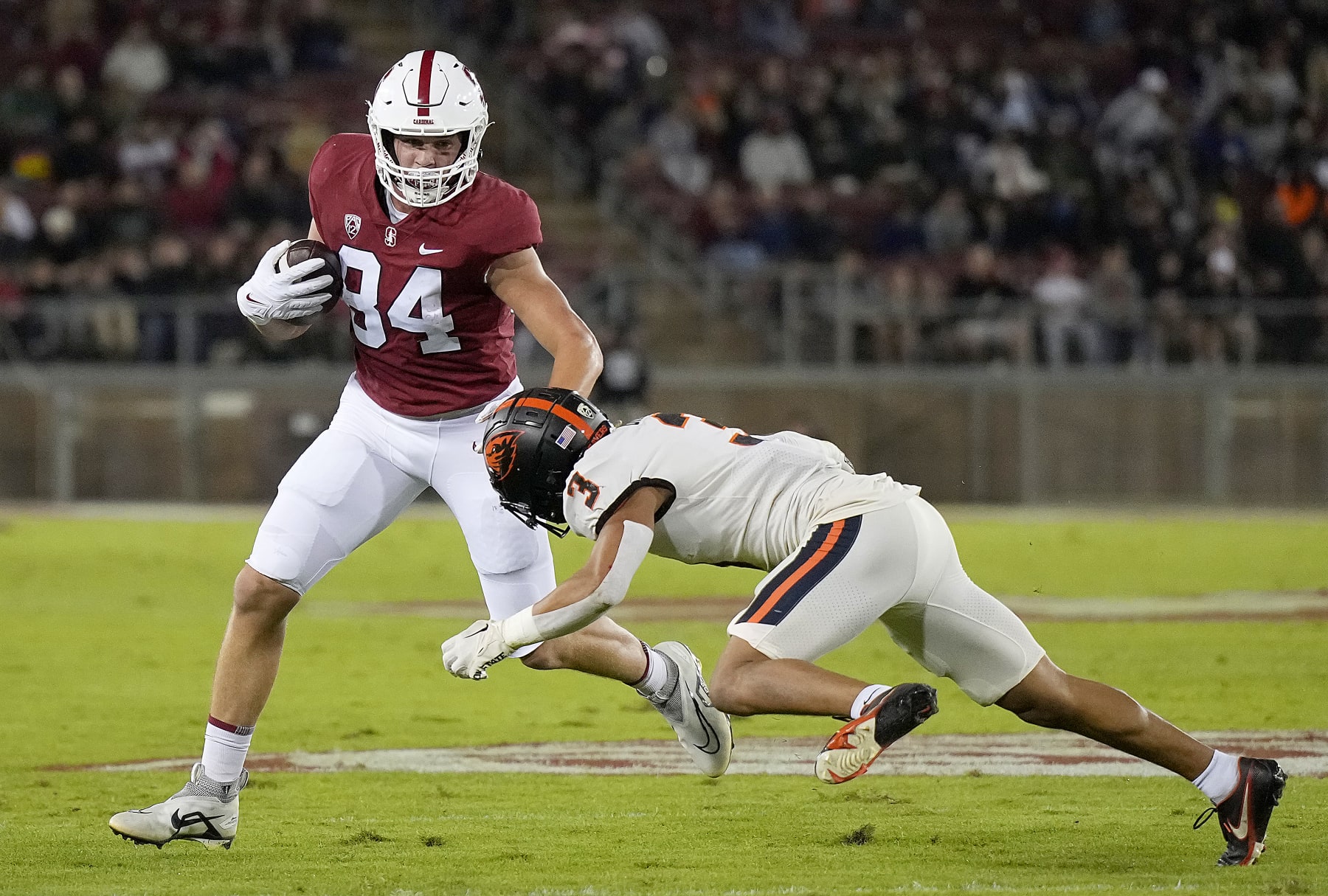 STANFORD, CALIFORNIA - OCTOBER 08: Benjamin Yurosek #84 of the Stanford Cardinal running with the ball after catching a pass fights off the tackle of Jaydon Grant #3 of the Oregon State Beavers in the first quarter at Stanford Stadium on October 08, 2022 in Stanford, California. (Photo by Thearon W. Henderson/Getty Images)