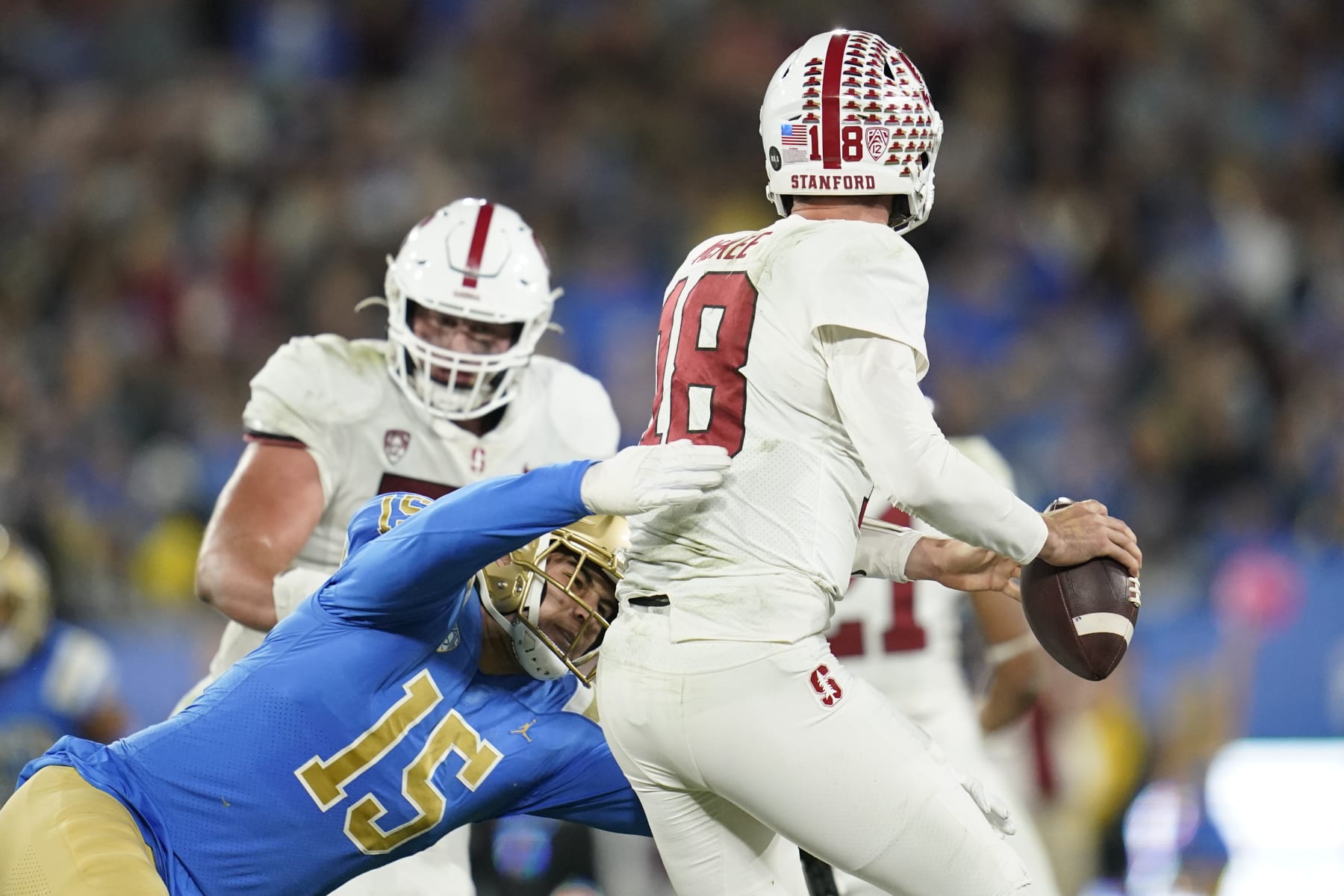 UCLA linebacker Laiatu Latu (15) sacks Stanford quarterback Tanner McKee (18) during the first half of an NCAA college football game in Pasadena, Calif., Saturday, Oct. 29, 2022. (AP Photo/Ashley Landis)