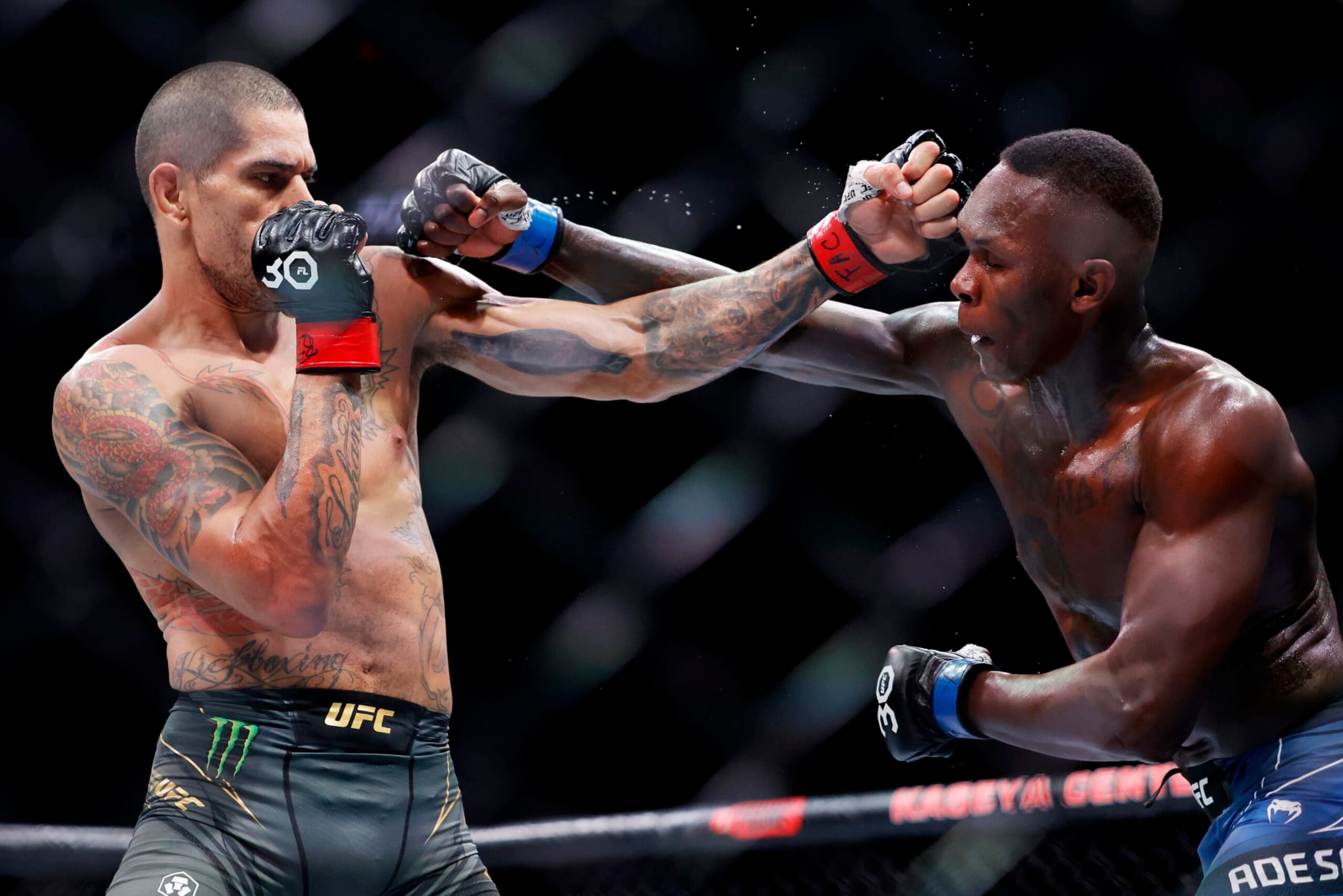 Alex Pereira (left) and Israel Adesanya trade punches. 