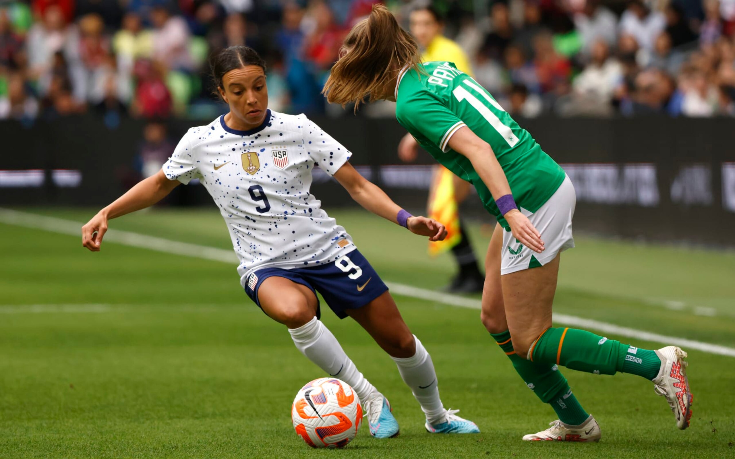 AUSTIN, TEXAS - APRIL 8: Mallory Swanson #9 of the United States competes with Heather Payne #14 of the Republic of Ireland during the first half of a 2023 International Friendly match at Q2 Stadium on April 8, 2023 in Austin, Texas. The United States won 2-0. (Photo by Ron Jenkins/Getty Images)