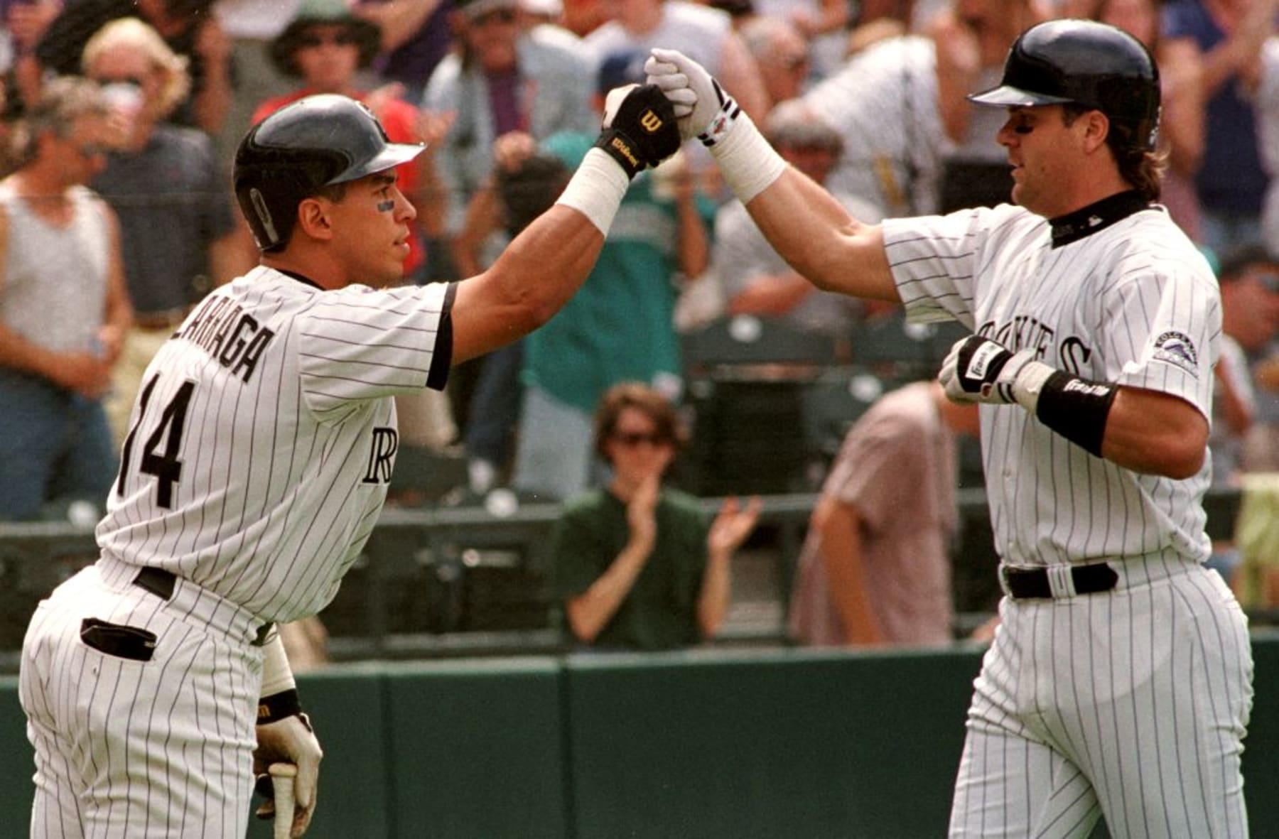 DENVER, CO - JUNE 7:  Larry Walker (R) of the Colorado Rockies is congratulated by teammate Andres Galarraga after Walker hit a solo home run during the first inning of their game against the Florida Marlins 07 June at Coors Field in Denver, Colorado. Galarraga (next in the lineup) also hit a solo home run as did Dante Bichette (who followed Galarraga) with the three hitting back to back home runs.The game was delayed in the fourth inning for rain.  (Photo credit should read DOUG COLLIER/AFP via Getty Images)