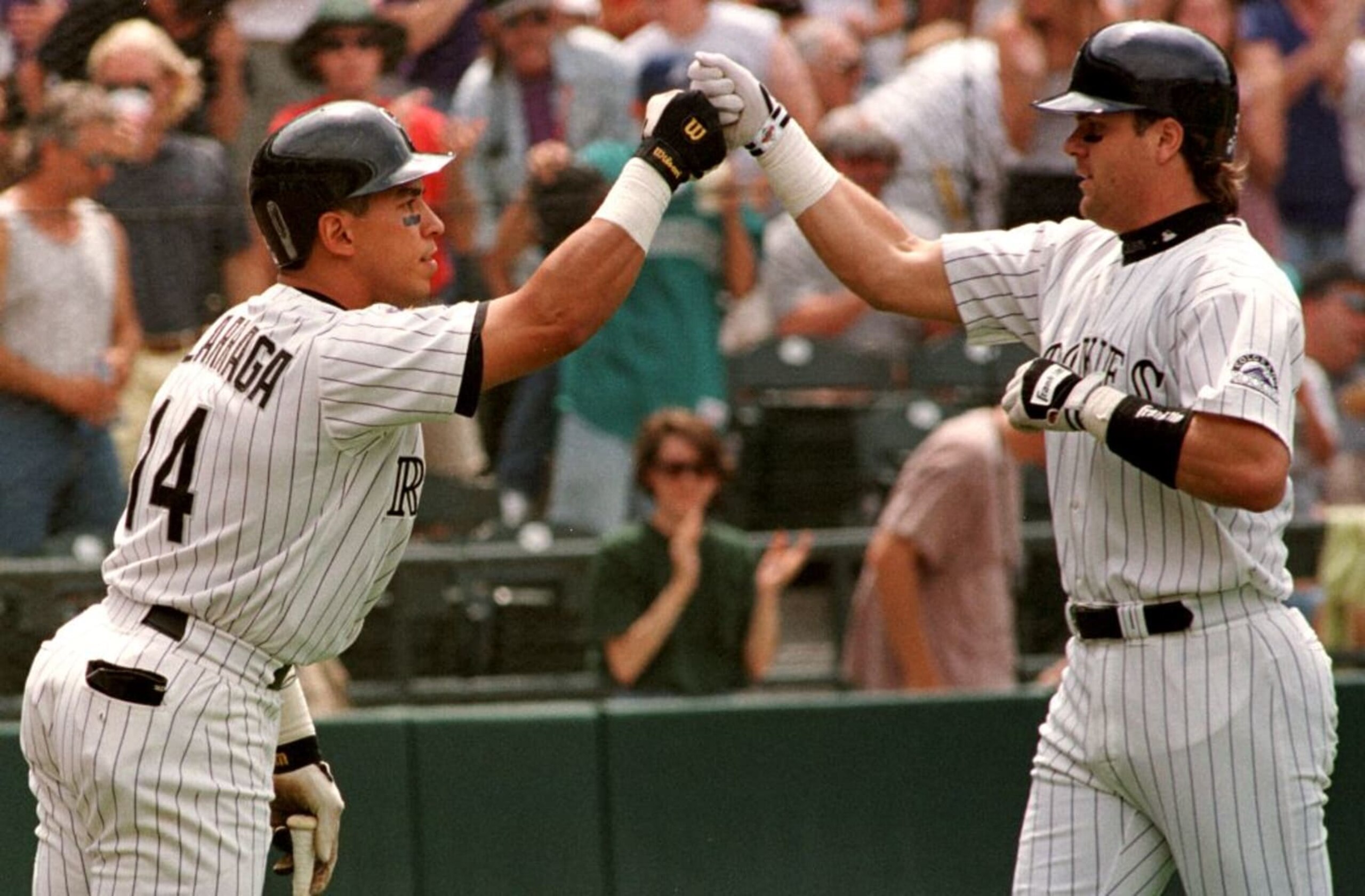 DENVER, CO - JUNE 7:  Larry Walker (R) of the Colorado Rockies is congratulated by teammate Andres Galarraga after Walker hit a solo home run during the first inning of their game against the Florida Marlins 07 June at Coors Field in Denver, Colorado. Galarraga (next in the lineup) also hit a solo home run as did Dante Bichette (who followed Galarraga) with the three hitting back to back home runs.The game was delayed in the fourth inning for rain.  (Photo credit should read DOUG COLLIER/AFP via Getty Images)