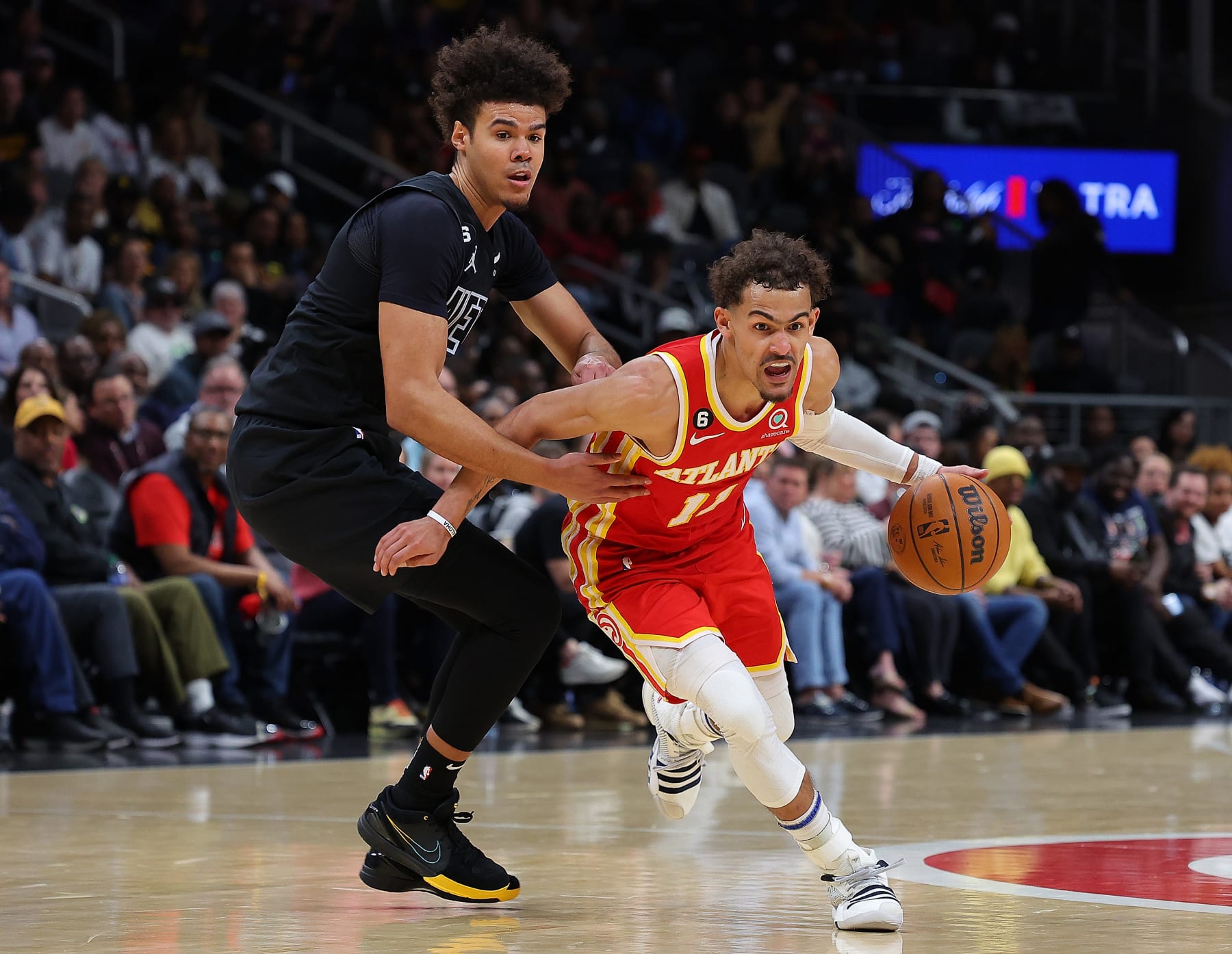 ATLANTA, GEORGIA - FEBRUARY 26:  Trae Young #11 of the Atlanta Hawks drives against Cameron Johnson #2 of the Brooklyn Nets during the fourth quarter at State Farm Arena on February 26, 2023 in Atlanta, Georgia.  NOTE TO USER: User expressly acknowledges and agrees that, by downloading and or using this photograph, User is consenting to the terms and conditions of the Getty Images License Agreement.  (Photo by Kevin C. Cox/Getty Images)