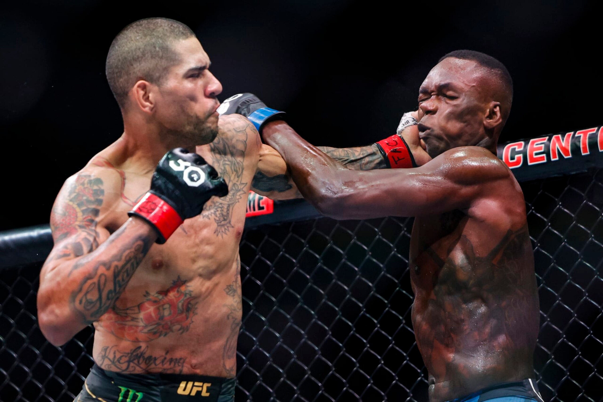 MIAMI, FLORIDA - APRIL 08: Alex Pereira of Brazil and Israel Adesanya of Nigeria exchange strikes during their Middleweight fight at Kaseya Center on April 08, 2023 in Miami, Florida. (Photo by Carmen Mandato/Getty Images)