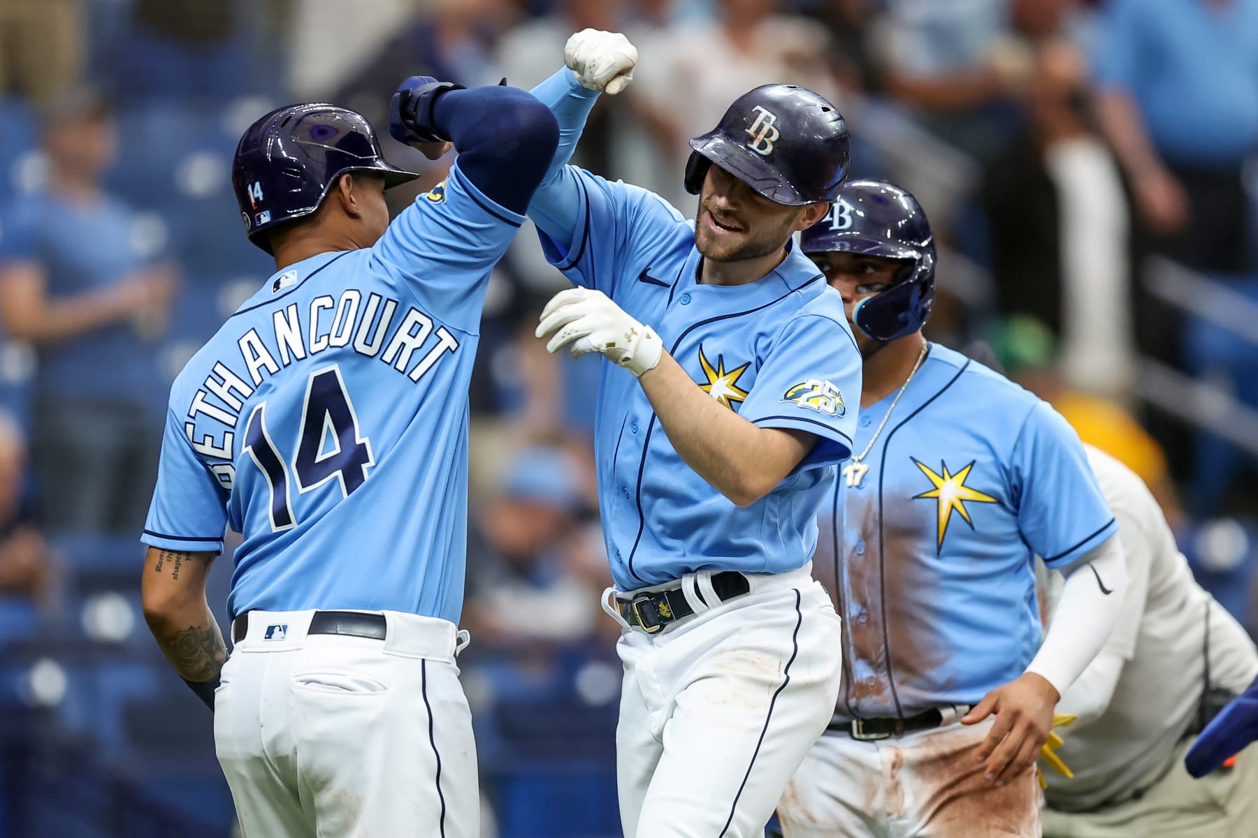 ST. PETERSBURG, FL - APRIL 9: Brandon Lowe #8 of the Tampa Bay Rays (C) celebrates his grand slam home run against the Oakland Athletics with Christian Bethancourt #14 (L) and Isaac Paredes #17 during the fourth inning of a baseball game at Tropicana Field on April 9, 2023 in St. Petersburg, Florida. (Photo by Mike Carlson/Getty Images)
