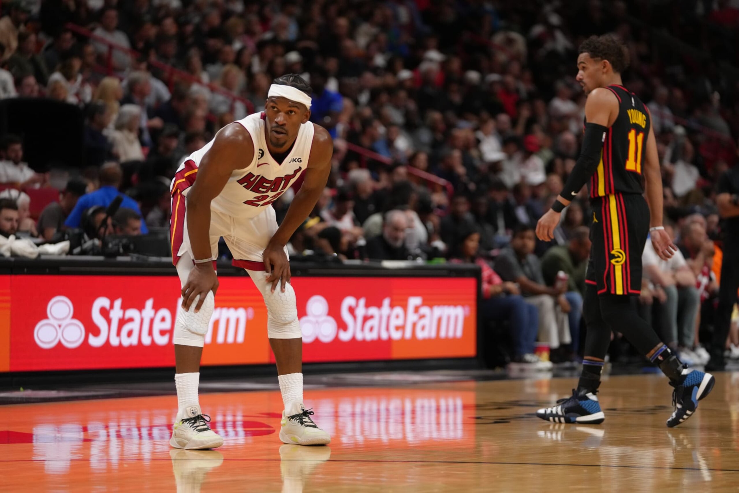 MIAMI, FL - APRIL 11: Jimmy Butler #22 of the Miami Heat and Trae Young #11 of the Atlanta Hawks look on during the 2023 Play-In Tournament on April 11, 2023 at Kaseya Center in Miami, Florida. NOTE TO USER: User expressly acknowledges and agrees that, by downloading and or using this Photograph, user is consenting to the terms and conditions of the Getty Images License Agreement. Mandatory Copyright Notice: Copyright 2023 NBAE (Photo by Eric Espada/NBAE via Getty Images)