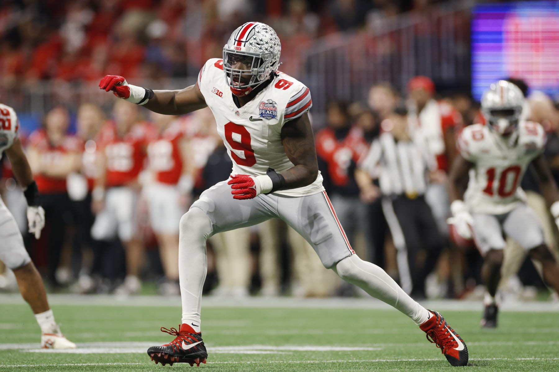 ATLANTA, GA - DECEMBER 31: Ohio State Buckeyes defensive end Zach Harrison (9) rushes on defense during the Chick-fil-A Peach Bowl semifinal game against the Georgia Bulldogs on December 31, 2022 at Mercedes-Benz Stadium in Atlanta, Georgia. (Photo by Joe Robbins/Icon Sportswire via Getty Images)