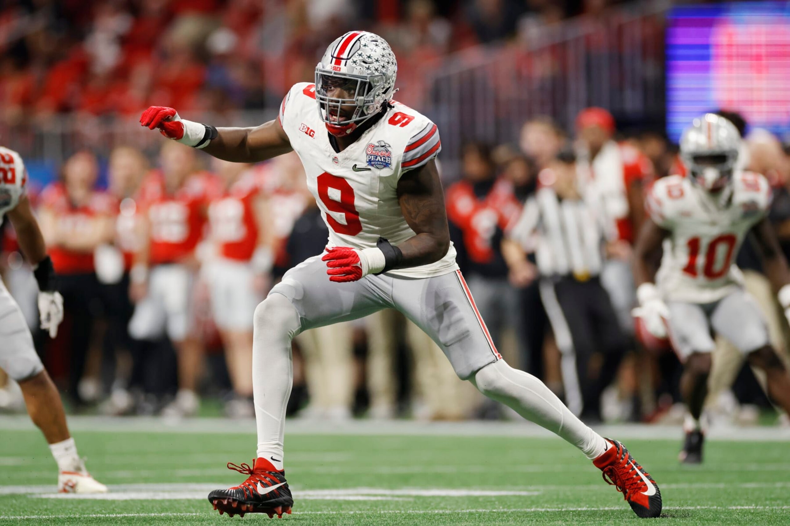 ATLANTA, GA - DECEMBER 31: Ohio State Buckeyes defensive end Zach Harrison (9) rushes on defense during the Chick-fil-A Peach Bowl semifinal game against the Georgia Bulldogs on December 31, 2022 at Mercedes-Benz Stadium in Atlanta, Georgia. (Photo by Joe Robbins/Icon Sportswire via Getty Images) ATLANTA, GA - DECEMBER 31: Ohio State Buckeyes defensive end Zach Harrison (9) rushes on defense during the Chick-fil-A Peach Bowl semifinal game against the Georgia Bulldogs on December 31, 2022 at Mercedes-Benz Stadium in Atlanta, Georgia. (Photo by Joe Robbins/Icon Sportswire via Getty Images)