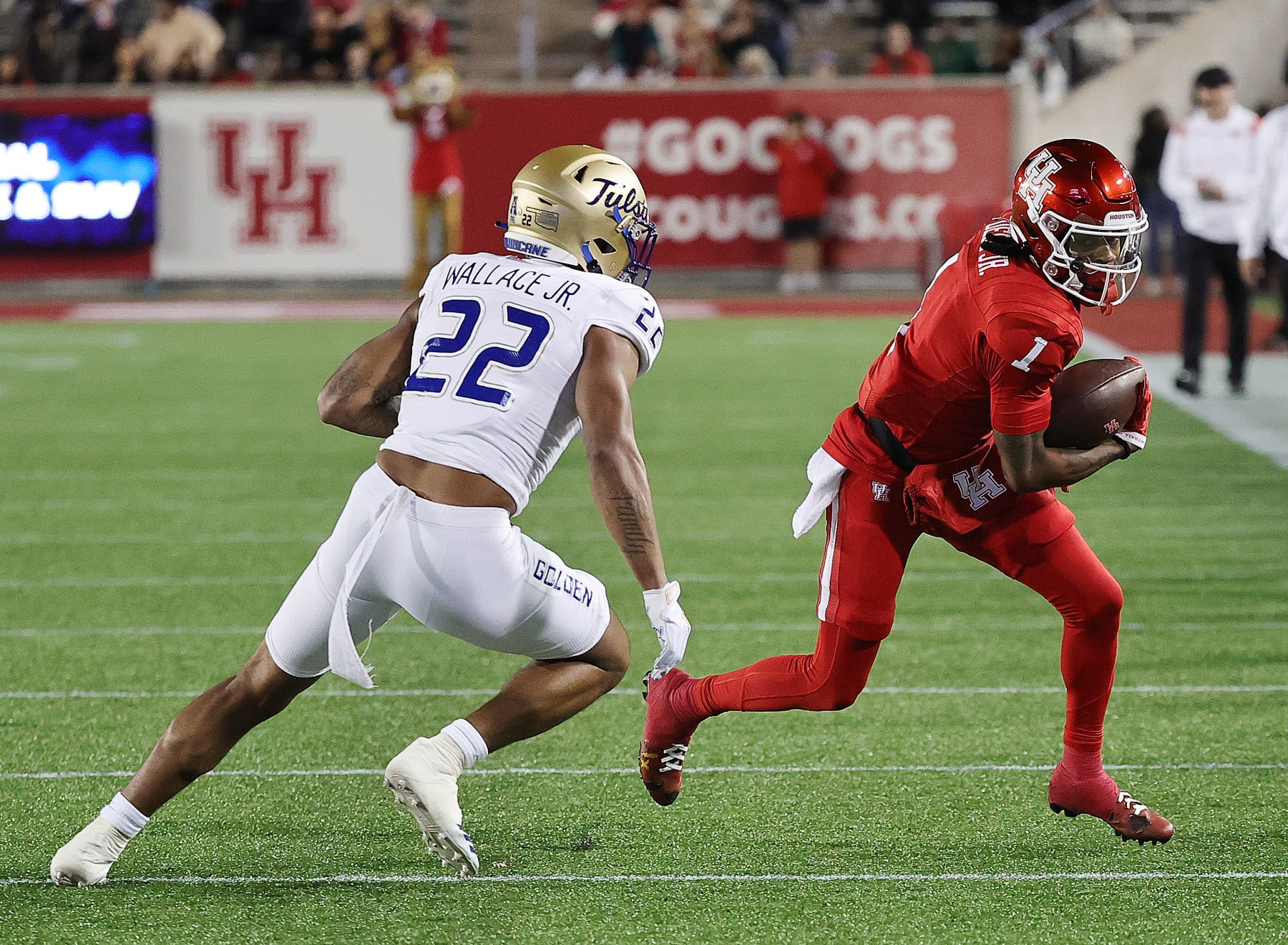 HOUSTON, TEXAS - NOVEMBER 26: Nathaniel Dell #1 of the Houston Cougars runs with the ball after a reception during the second quarter as LJ Wallace #22 of the Tulsa Golden Hurricane looks to make a tackle at TDECU Stadium on November 26, 2022 in Houston, Texas. (Photo by Bob Levey/Getty Images)