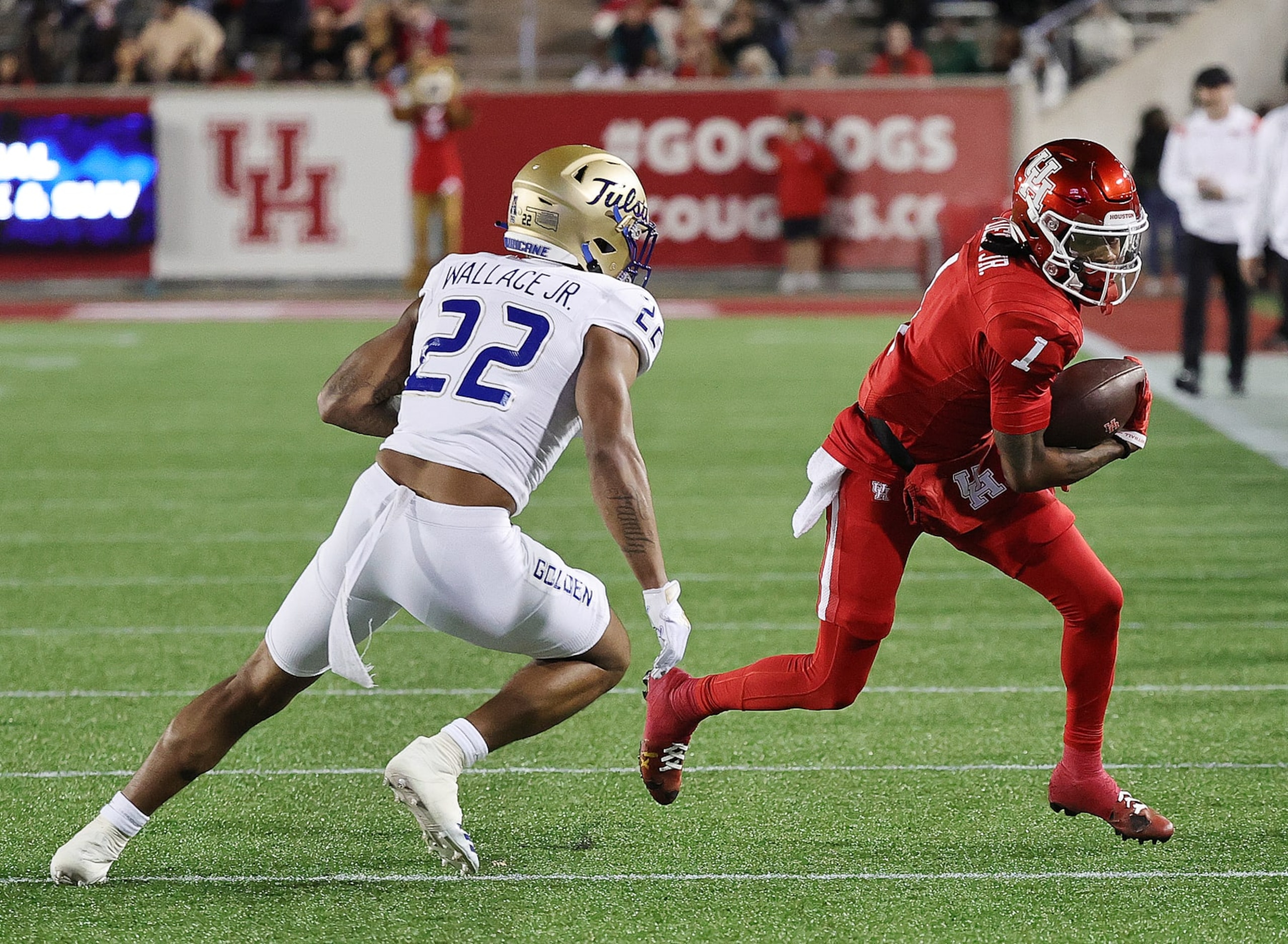 HOUSTON, TEXAS - NOVEMBER 26: Nathaniel Dell #1 of the Houston Cougars runs with the ball after a reception during the second quarter as LJ Wallace #22 of the Tulsa Golden Hurricane looks to make a tackle at TDECU Stadium on November 26, 2022 in Houston, Texas. (Photo by Bob Levey/Getty Images)