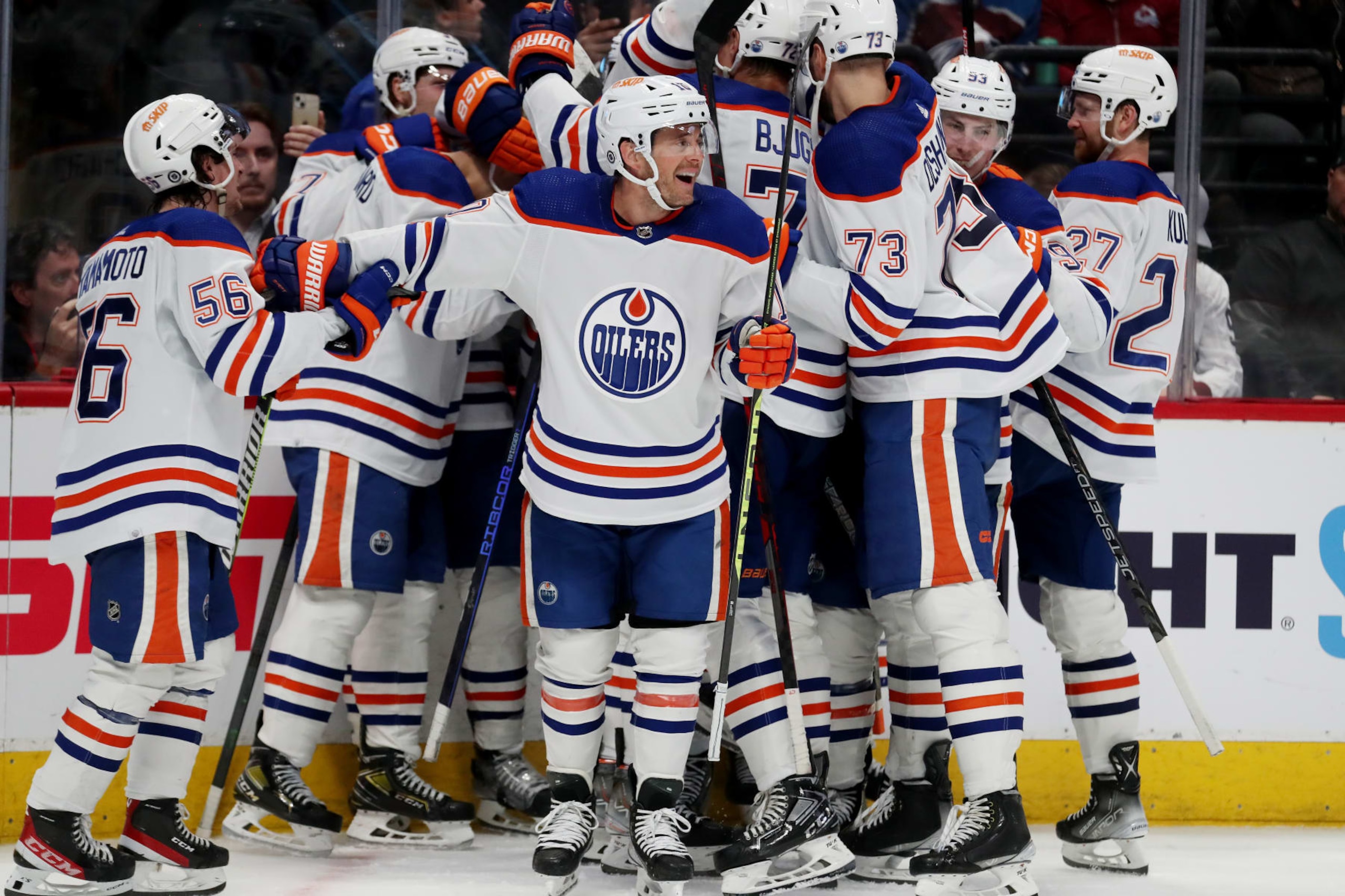 DENVER, COLORADO - APRIL 11: Kailer Yamamoto #56, Derek Ryan #10 and the Edmonton Oilers celebrate a 2-1 overtime win against the Colorado Avalanche at Ball Arena on April 11, 2023 in Denver, Colorado. (Photo by Michael Martin/NHLI via Getty Images)