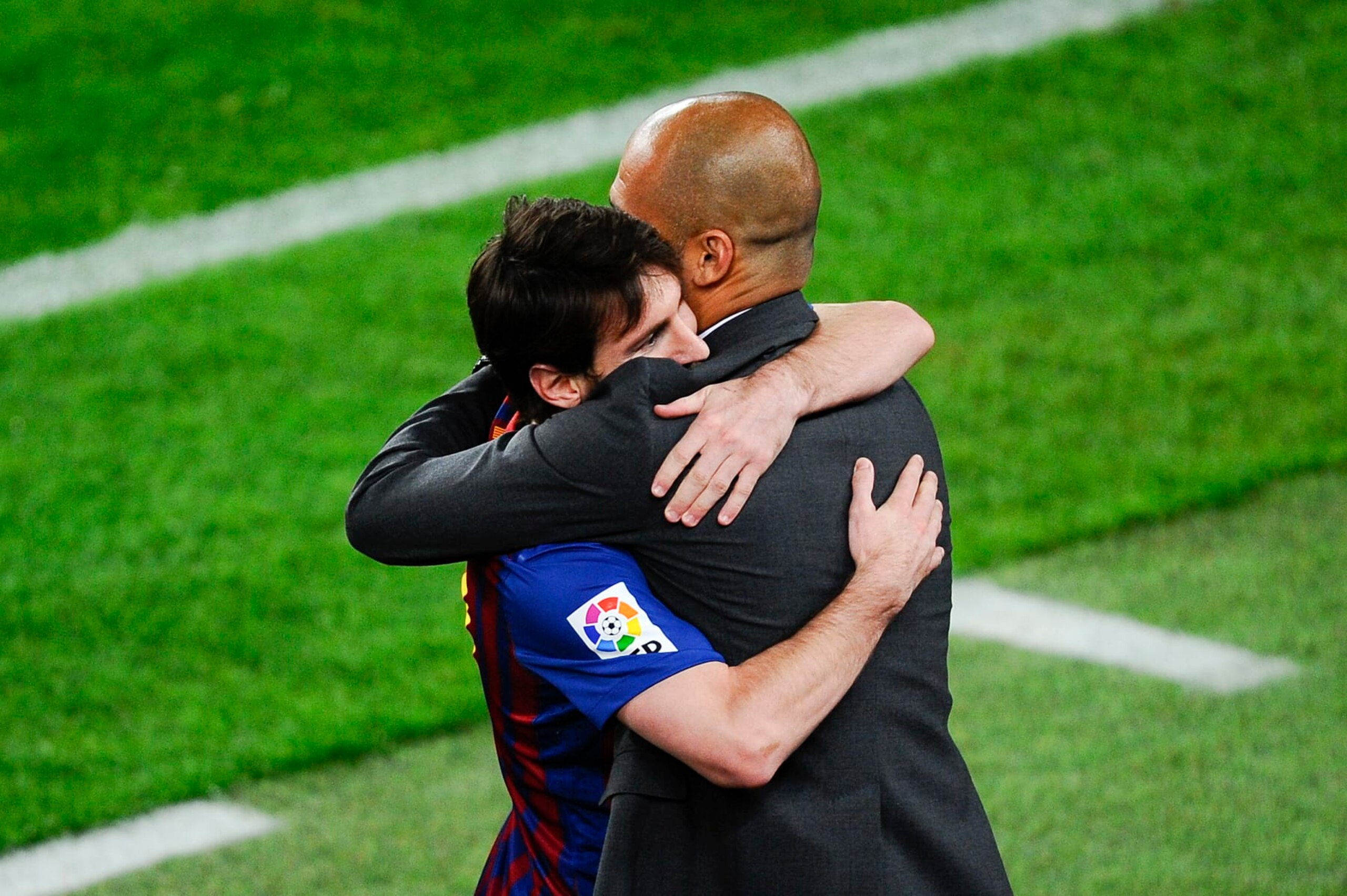 BARCELONA, SPAIN - MAY 05:  Lionel Messi of FC Barcelona (R) hugs his Head coach Josep Guardiola of FC Barcelona after scoring his team's third goal during the La Liga match between FC Barcelona and RCD Espanyol at Camp Nou on May 5, 2012 in Barcelona, Spain. This is the last match as head coach of FC Barcelona for Josep Guardiola at the Camp Nou Stadium.  (Photo by David Ramos/Getty Images)
