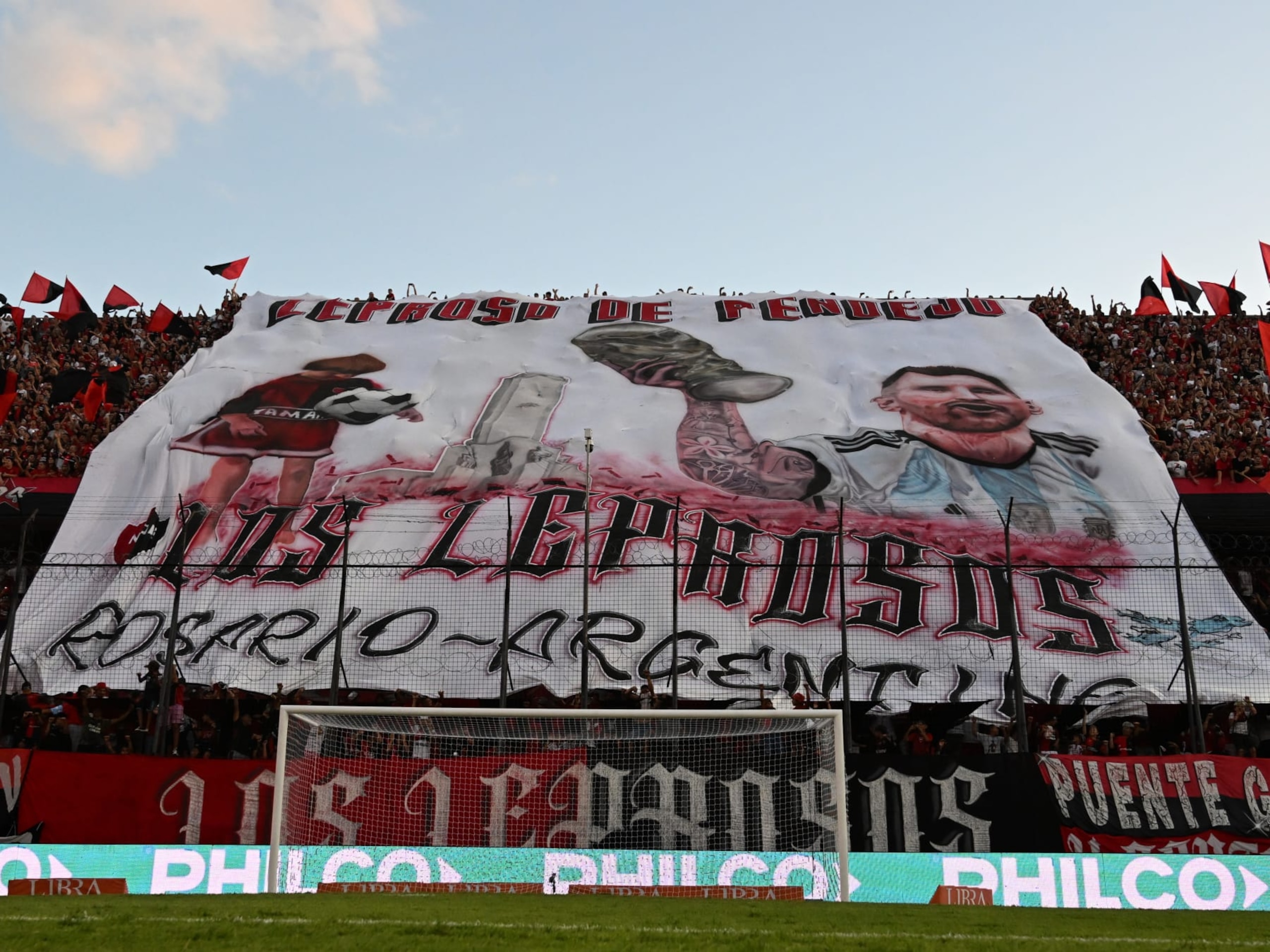 ROSARIO, ARGENTINA - FEBRUARY 03: Fans of Newell´s Old Boys display a flag with the image of Lionel Messi holding the World Cup Trophy previous a match between Newell's Old Boys and Velez as part of Liga Profesional 2023 at Marcelo Bielsa Stadium on February 3, 2023 in Rosario, Argentina. (Photo by Luciano Bisbal/Getty Images)
