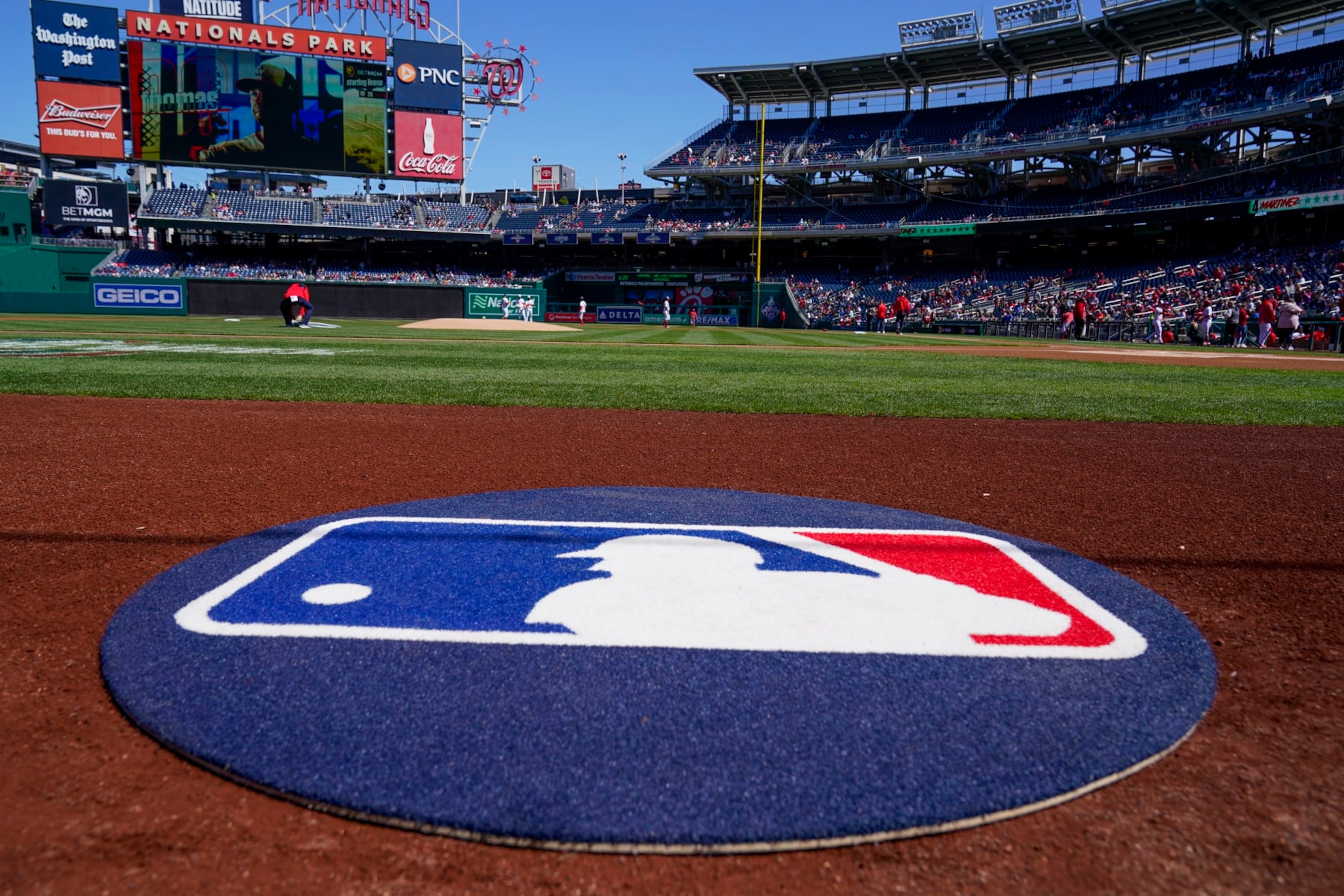 The on-deck circle with the MLB logo is in place before a baseball game between the Washington Nationals and the Atlanta Braves at Nationals Park, Sunday, April 2, 2023, in Washington. (AP Photo/Alex Brandon)