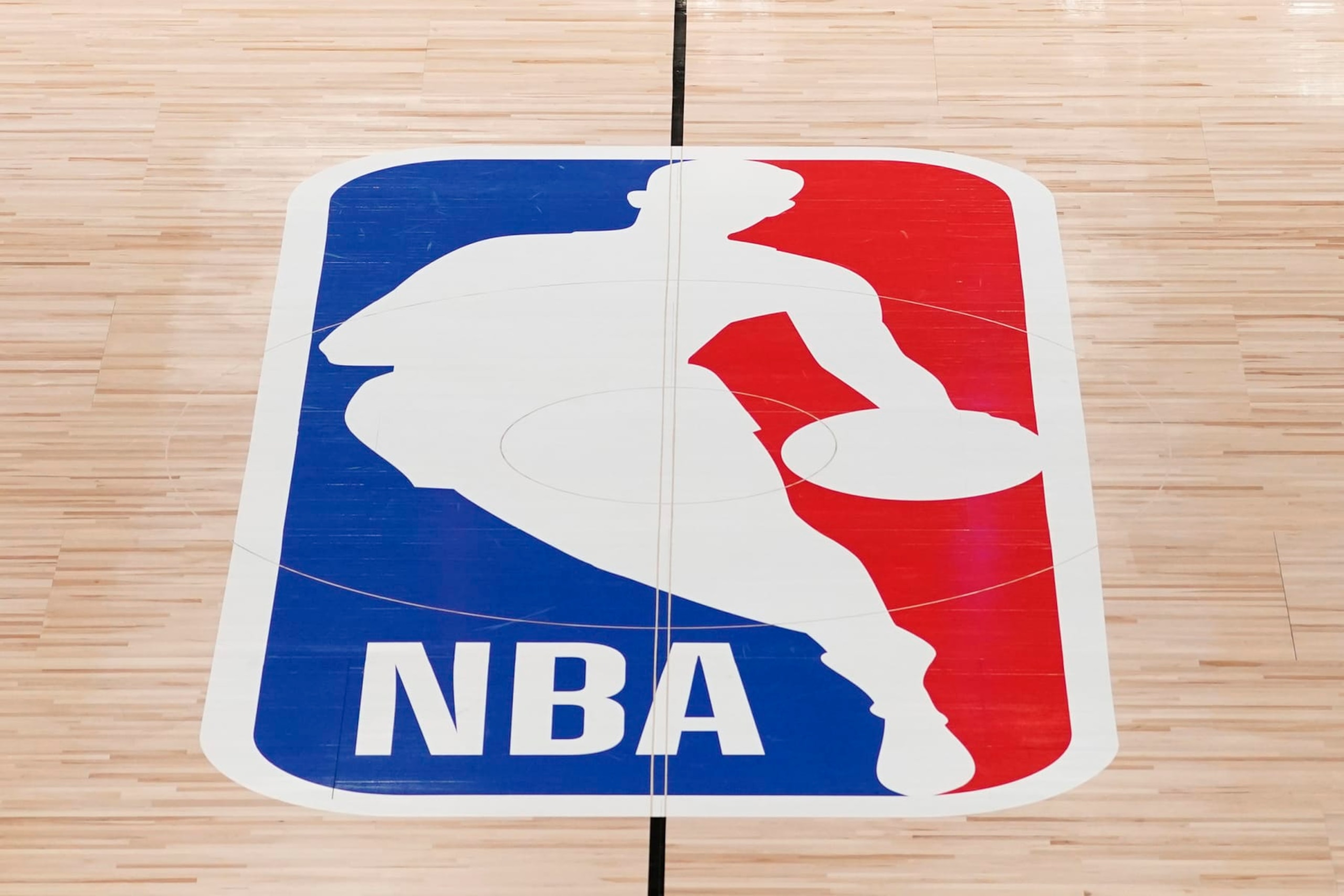 FILE - The NBA logo in shown on a basketball court in Lake Buena Vista, Fla., in this Friday, Aug. 28, 2020, file photo. Pacers coach Rick Carlisle says his new team has a “very high” vaccination rate but declined to give a specific number because of privacy concerns. He did say Monday during NBA media day that all members of the Indiana coaching staff are fully vaccinated. Carlisle is back in Indiana, where he coached from 2003 through 2007. Training camps open Tuesday and the pandemic will affect a third NBA season and already means some players will be missing on media day.(AP Photo/Ashley Landis, Pool, File) FILE - The NBA logo in shown on a basketball court in Lake Buena Vista, Fla., in this Friday, Aug. 28, 2020, file photo. Pacers coach Rick Carlisle says his new team has a “very high” vaccination rate but declined to give a specific number because of privacy concerns. He did say Monday during NBA media day that all members of the Indiana coaching staff are fully vaccinated. Carlisle is back in Indiana, where he coached from 2003 through 2007. Training camps open Tuesday and the pandemic will affect a third NBA season and already means some players will be missing on media day.(AP Photo/Ashley Landis, Pool, File)