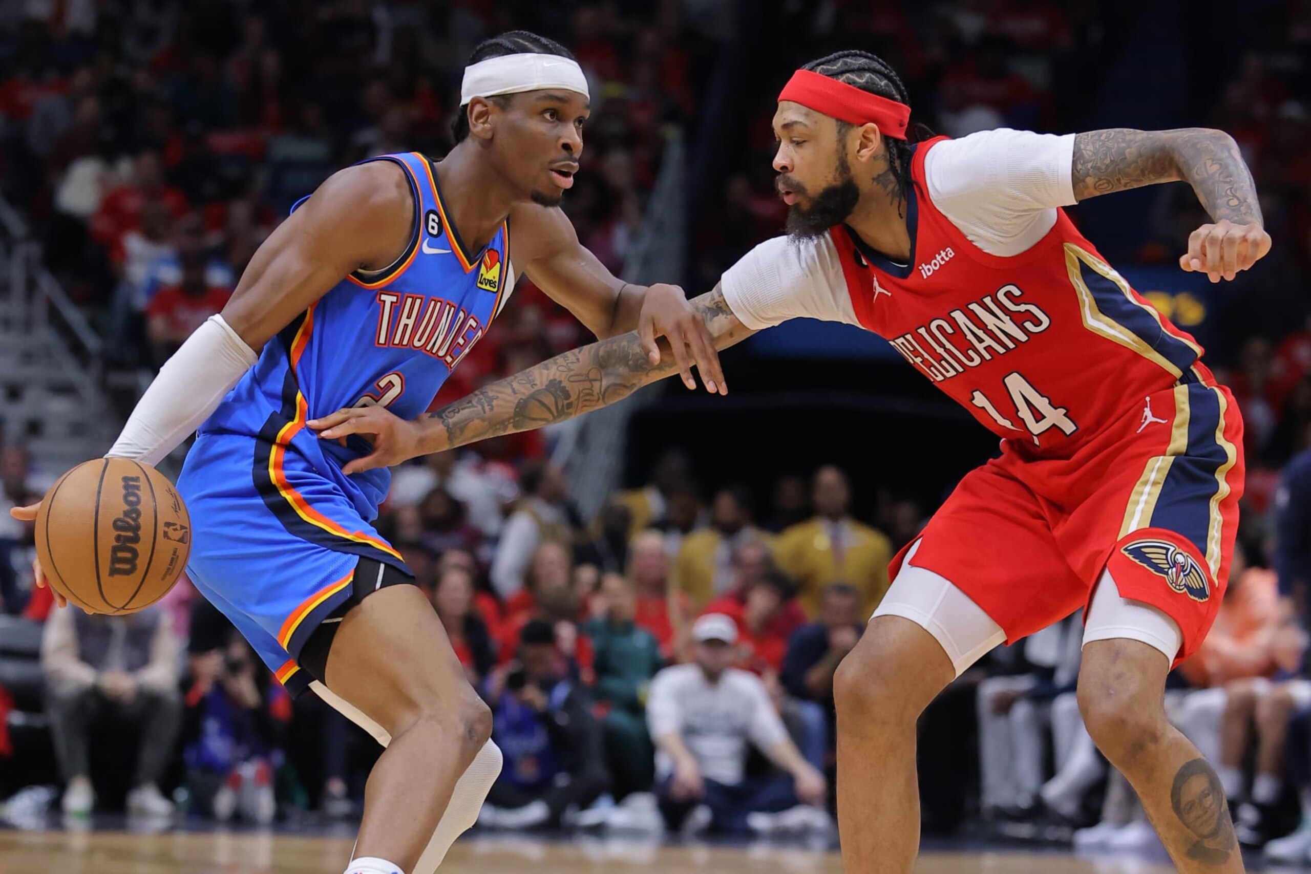 NEW ORLEANS, LOUISIANA - APRIL 12: Shai Gilgeous-Alexander #2 of the Oklahoma City Thunder drives against Brandon Ingram #14 of the New Orleans Pelicans during the first half at the Smoothie King Center on April 12, 2023 in New Orleans, Louisiana. NOTE TO USER: User expressly acknowledges and agrees that, by downloading and or using this Photograph, user is consenting to the terms and conditions of the Getty Images License Agreement. (Photo by Jonathan Bachman/Getty Images) NEW ORLEANS, LOUISIANA - APRIL 12: Shai Gilgeous-Alexander #2 of the Oklahoma City Thunder drives against Brandon Ingram #14 of the New Orleans Pelicans during the first half at the Smoothie King Center on April 12, 2023 in New Orleans, Louisiana. NOTE TO USER: User expressly acknowledges and agrees that, by downloading and or using this Photograph, user is consenting to the terms and conditions of the Getty Images License Agreement. (Photo by Jonathan Bachman/Getty Images)