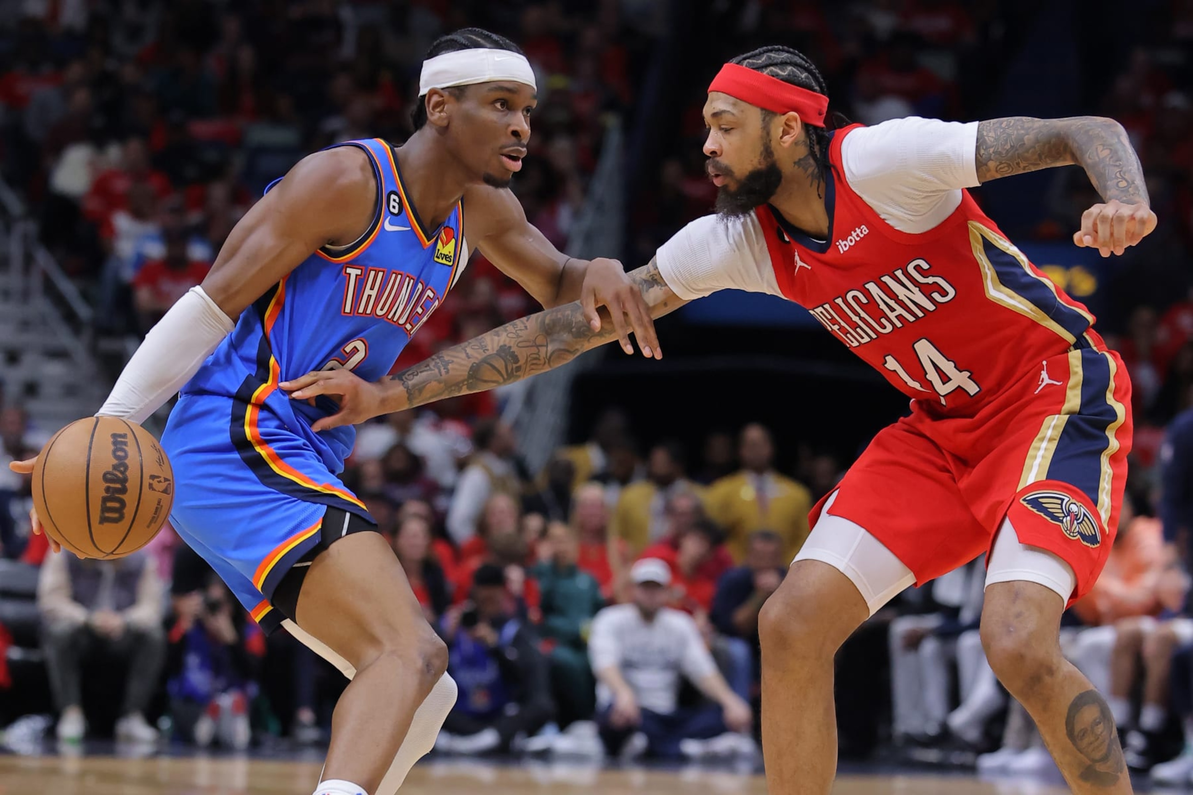 NEW ORLEANS, LOUISIANA - APRIL 12: Shai Gilgeous-Alexander #2 of the Oklahoma City Thunder drives against Brandon Ingram #14 of the New Orleans Pelicans during the first half at the Smoothie King Center on April 12, 2023 in New Orleans, Louisiana. NOTE TO USER: User expressly acknowledges and agrees that, by downloading and or using this Photograph, user is consenting to the terms and conditions of the Getty Images License Agreement. (Photo by Jonathan Bachman/Getty Images)
