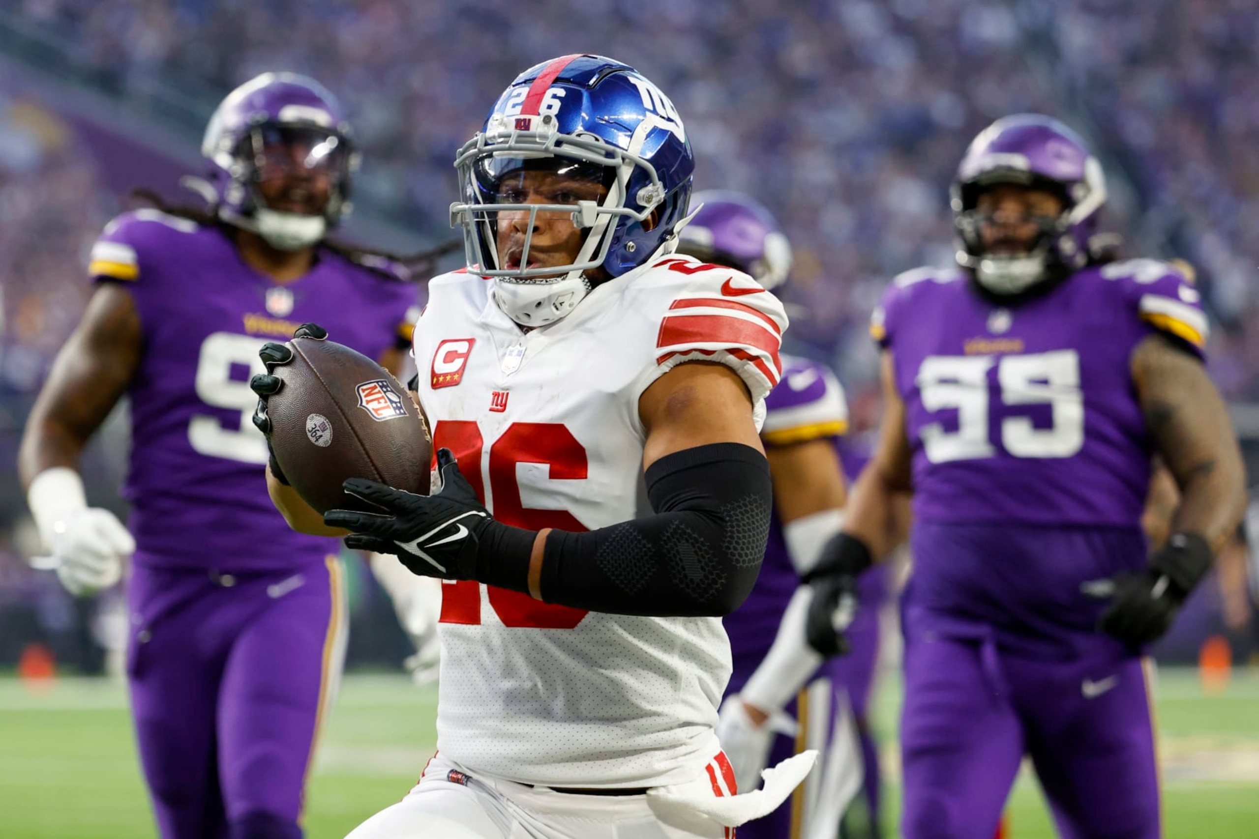 MINNEAPOLIS, MINNESOTA - JANUARY 15: Saquon Barkley #26 of the New York Giants rushes for a touchdown during the first quarter against the Minnesota Vikings in the NFC Wild Card playoff game at U.S. Bank Stadium on January 15, 2023 in Minneapolis, Minnesota. (Photo by David Berding/Getty Images)