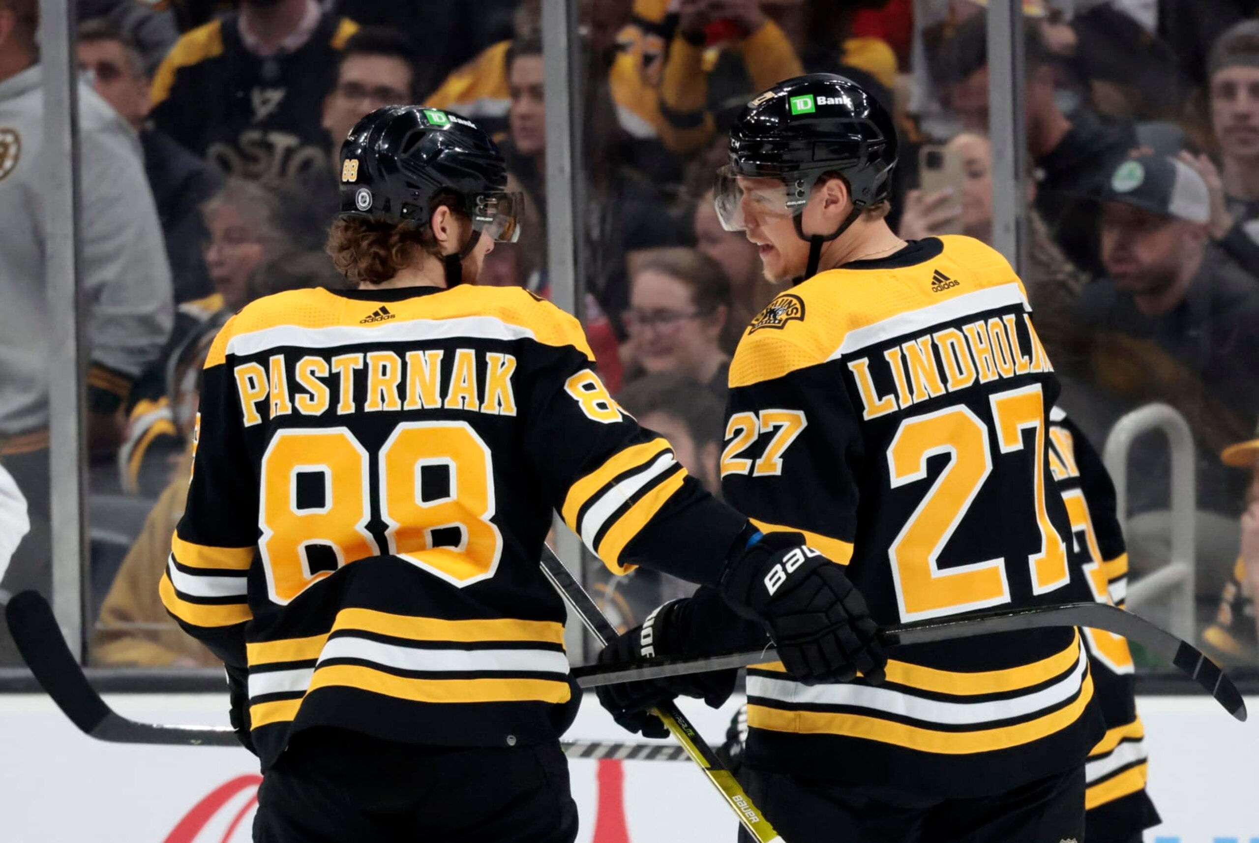 BOSTON, MA - APRIL 11: Boston Bruins right wing David Pastrnak (88) and Boston Bruins defenseman Hampus Lindholm (27) confer during a game between the Boston Bruins and the Washington Capitals on April 11, 2023, at TD Garden in Boston, Massachusetts. (Photo by Fred Kfoury III/Icon Sportswire via Getty Images)