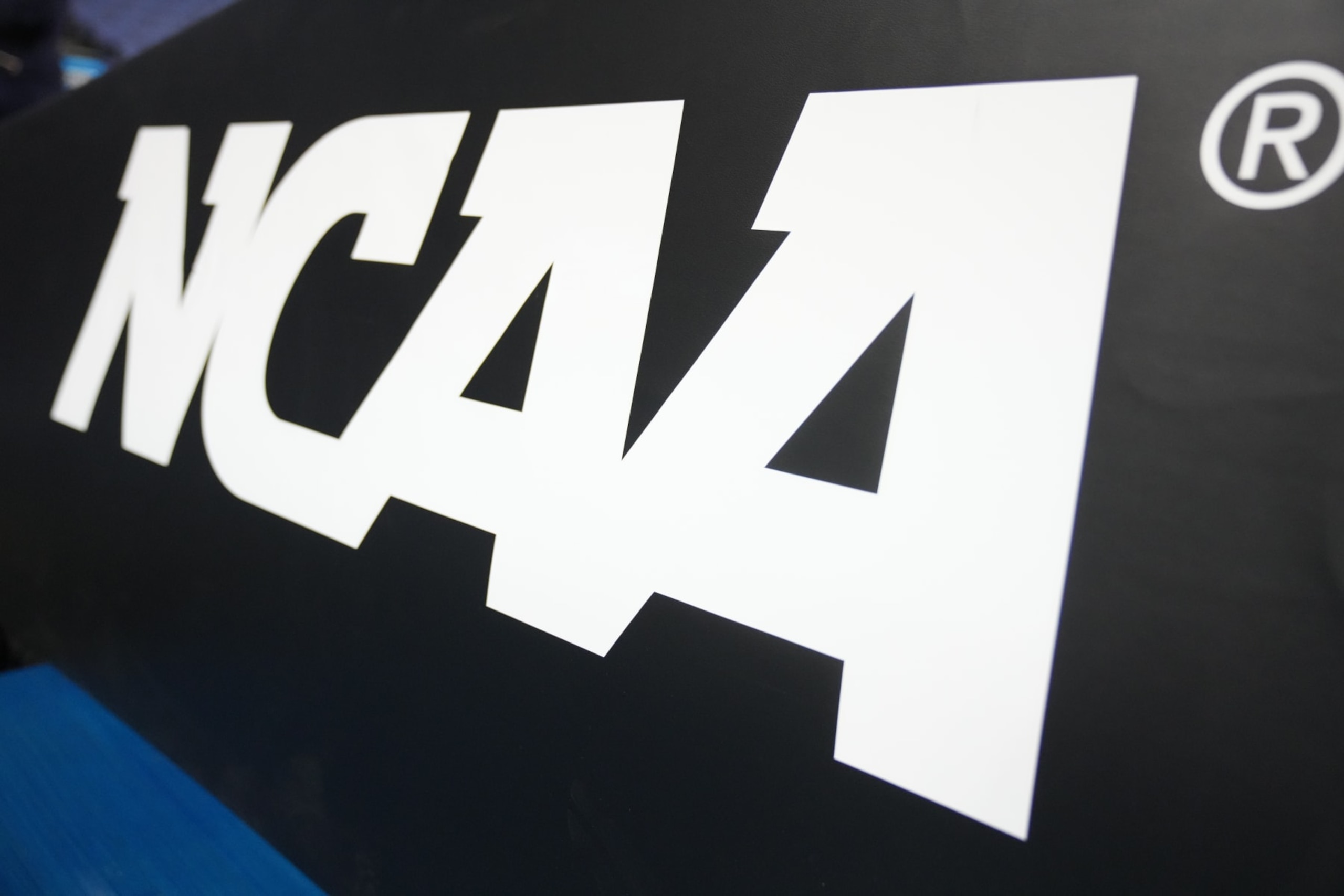 GREENSBORO, NORTH CAROLINA - MARCH 19: The NCAA logo on basketball pad before the second round of the 2023 NCAA Men's Basketball Tournament game between the Xavier Musketeers and the Pittsburgh Panthers at Greensboro Coliseum on March 19, 2023 in Greensboro, North Carolina. (Photo by Mitchell Layton/Getty Images) GREENSBORO, NORTH CAROLINA - MARCH 19: The NCAA logo on basketball pad before the second round of the 2023 NCAA Men's Basketball Tournament game between the Xavier Musketeers and the Pittsburgh Panthers at Greensboro Coliseum on March 19, 2023 in Greensboro, North Carolina. (Photo by Mitchell Layton/Getty Images)