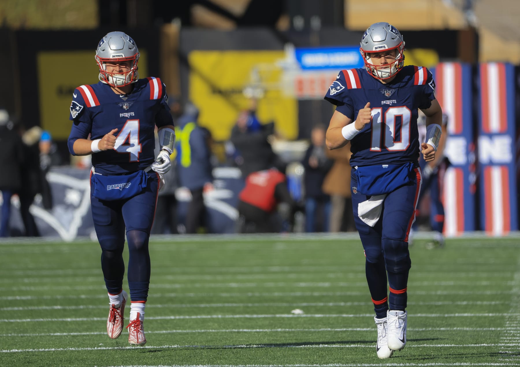 Foxborough, MA - November 20: New England QBs Bailey Zappe, left, and Mac Jones jog out onto the field before the game. The Patriots beat the New York Jets, 10-3. (Photo by Matthew J. Lee/The Boston Globe via Getty Images)