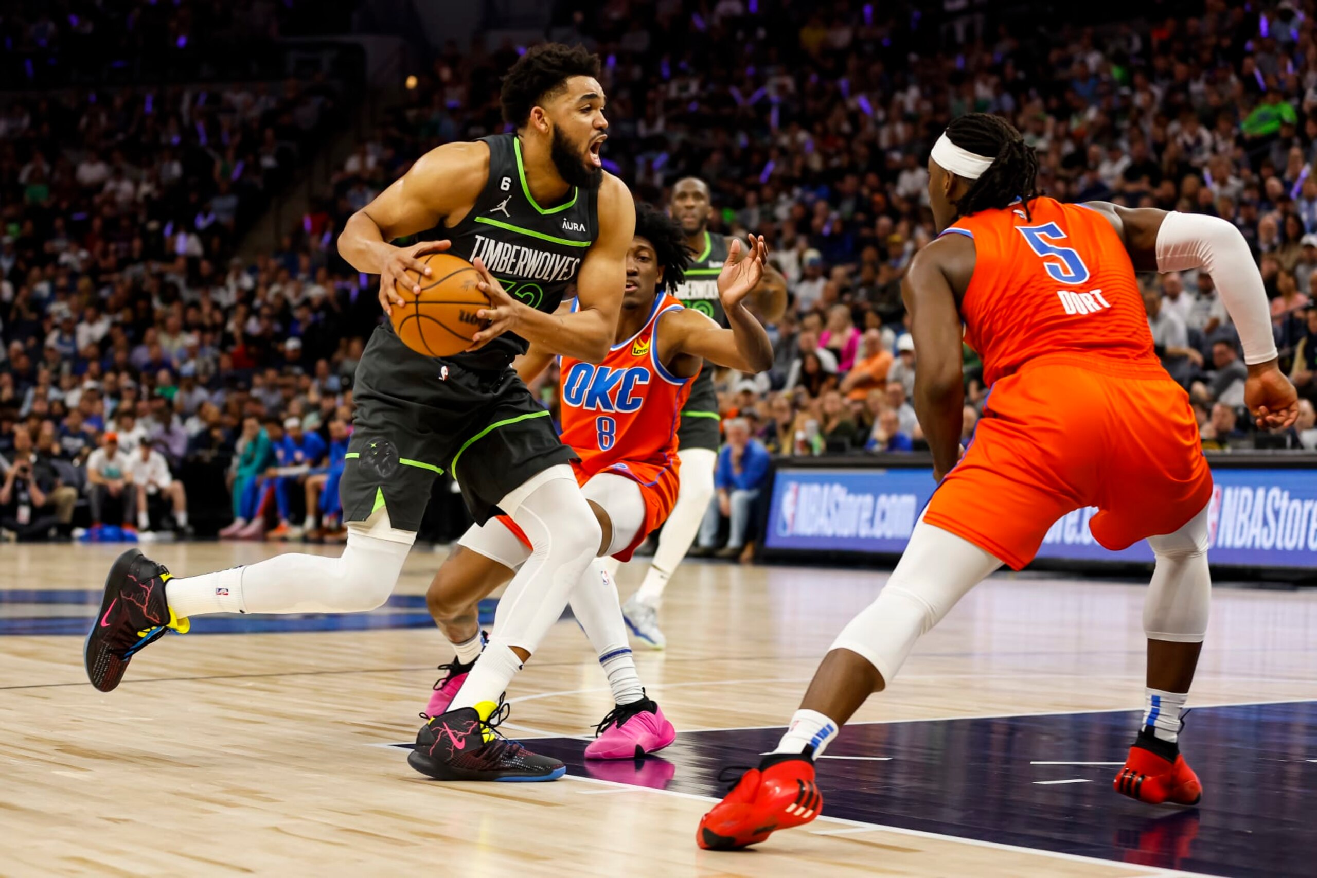 MINNEAPOLIS, MN - APRIL 14: Karl-Anthony Towns #32 of the Minnesota Timberwolves drives to the basket while Luguentz Dort #5 of the Oklahoma City Thunder defends in the second quarter of the NBA Play-In game at Target Center on April 14, 2023 in Minneapolis, Minnesota. NOTE TO USER: User expressly acknowledges and agrees that, by downloading and or using this Photograph, user is consenting to the terms and conditions of the Getty Images License Agreement. (Photo by David Berding/Getty Images)