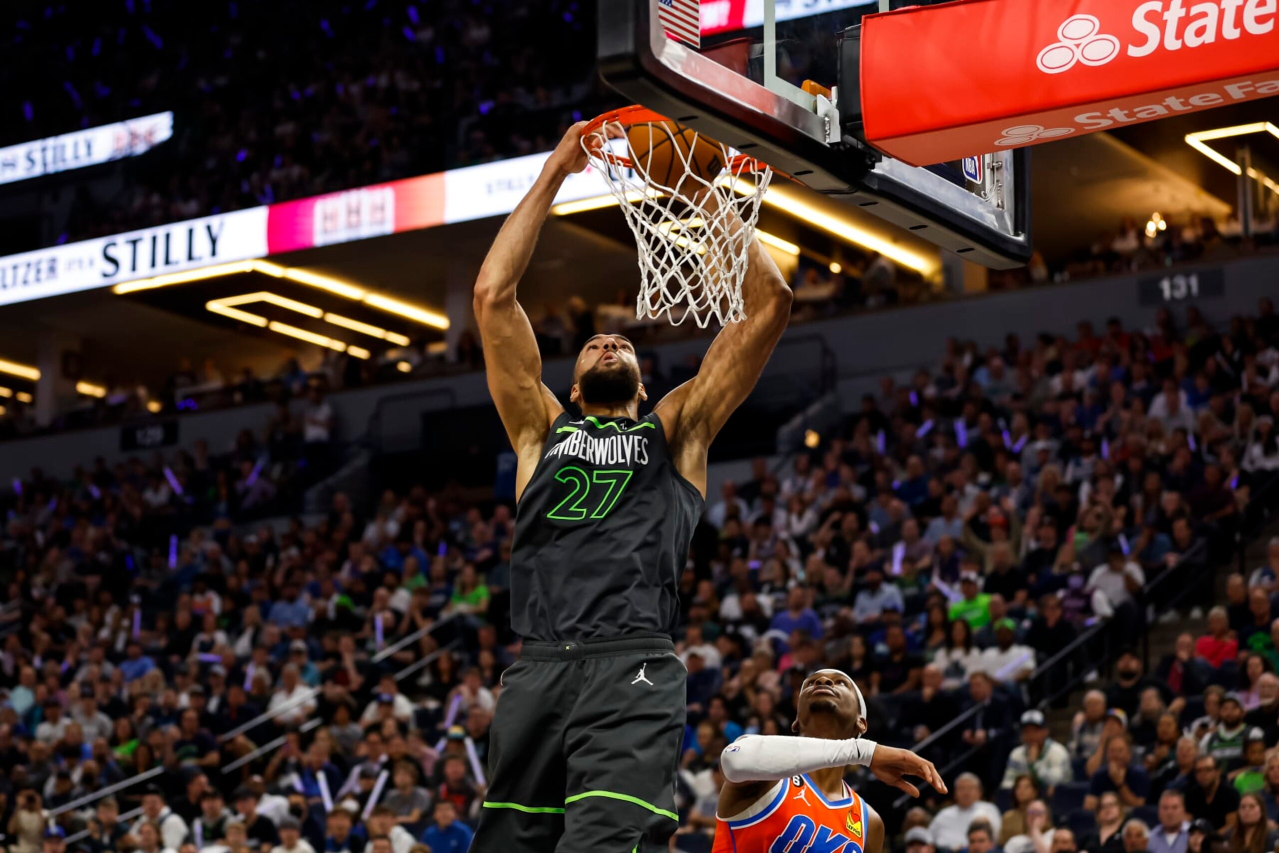 MINNEAPOLIS, MN - APRIL 14: Rudy Gobert #27 of the Minnesota Timberwolves dunks the ball on an alley-oop while Shai Gilgeous-Alexander #2 of the Oklahoma City Thunder looks on in the second quarter of the NBA Play-In game at Target Center on April 14, 2023 in Minneapolis, Minnesota. NOTE TO USER: User expressly acknowledges and agrees that, by downloading and or using this Photograph, user is consenting to the terms and conditions of the Getty Images License Agreement. (Photo by David Berding/Getty Images)