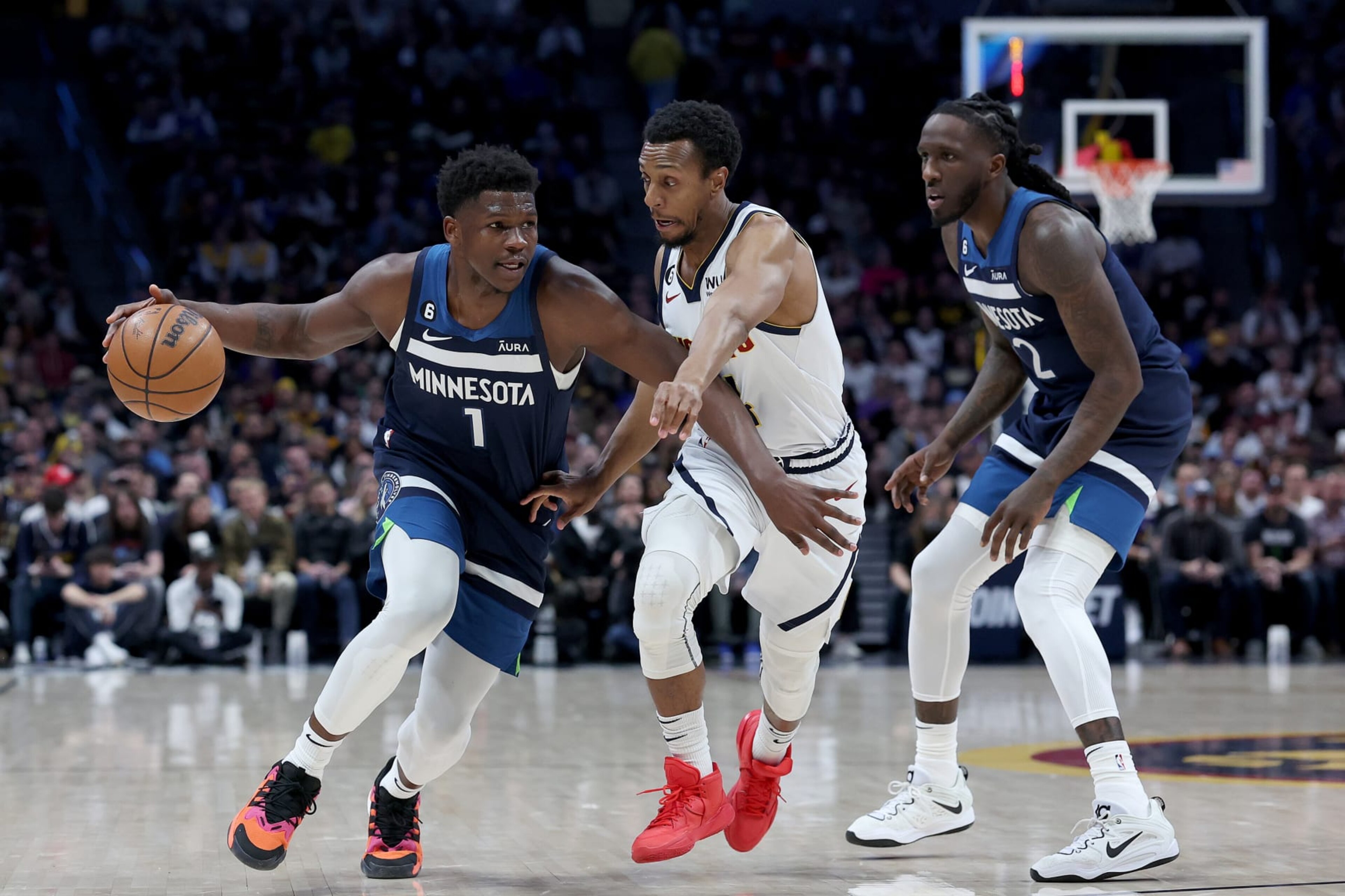 DENVER, COLORADO - FEBRUARY 07:  Anthony Edwards #1 of the Minnesota Timberwolves drives against Ish Smith #14 of the Denver Nuggets in the first quarter at Ball Arena on February 7, 2023 in Denver, Colorado. NOTE TO USER: User expressly acknowledges and agrees that, by downloading and/or using this photograph, User is consenting to the terms and conditions of the Getty Images License Agreement. (Photo by Matthew Stockman/Getty Images)