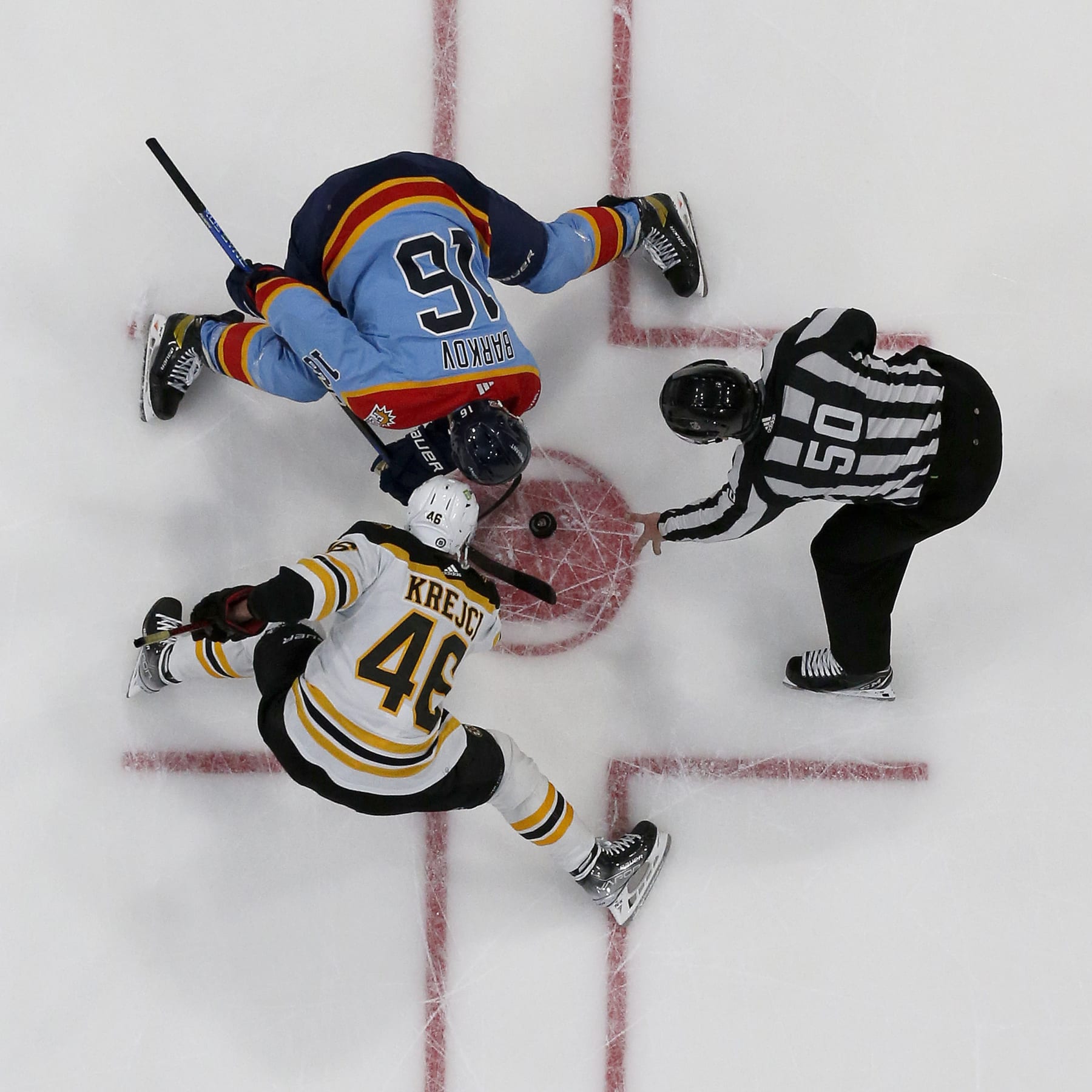 SUNRISE, FLORIDA - JANUARY 28: NHL Linesmen Scott Cherrey #50 drops the puck for a face off between David Krejci #46 of the Boston Bruins and Aleksander Barkov #16 of the Florida Panthers at the FLA Live Arena on January 28, 2023 in Sunrise, Florida. (Photo by Eliot J. Schechter/NHLI via Getty Images)