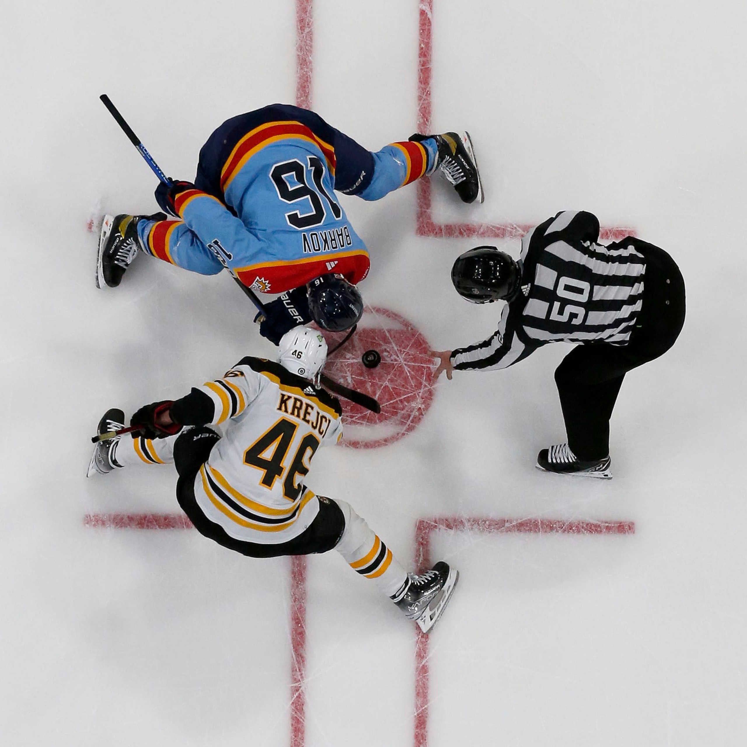 SUNRISE, FLORIDA - JANUARY 28: NHL Linesmen Scott Cherrey #50 drops the puck for a face off between David Krejci #46 of the Boston Bruins and Aleksander Barkov #16 of the Florida Panthers at the FLA Live Arena on January 28, 2023 in Sunrise, Florida. (Photo by Eliot J. Schechter/NHLI via Getty Images)