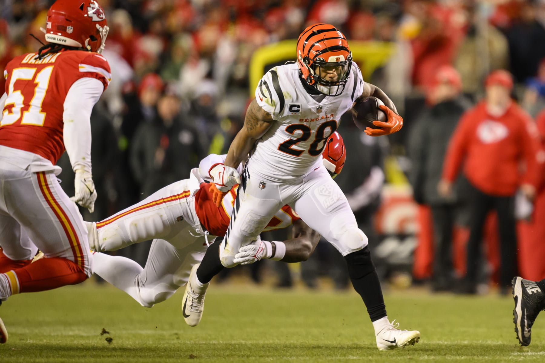 Cincinnati Bengals running back Joe Mixon (28) sheds an attempted tackle by Kansas City Chiefs linebacker Willie Gay (50) during the second half of the NFL AFC Championship playoff football game, Sunday, Jan. 29, 2023 in Kansas City, Mo. (AP Photo/Reed Hoffmann)