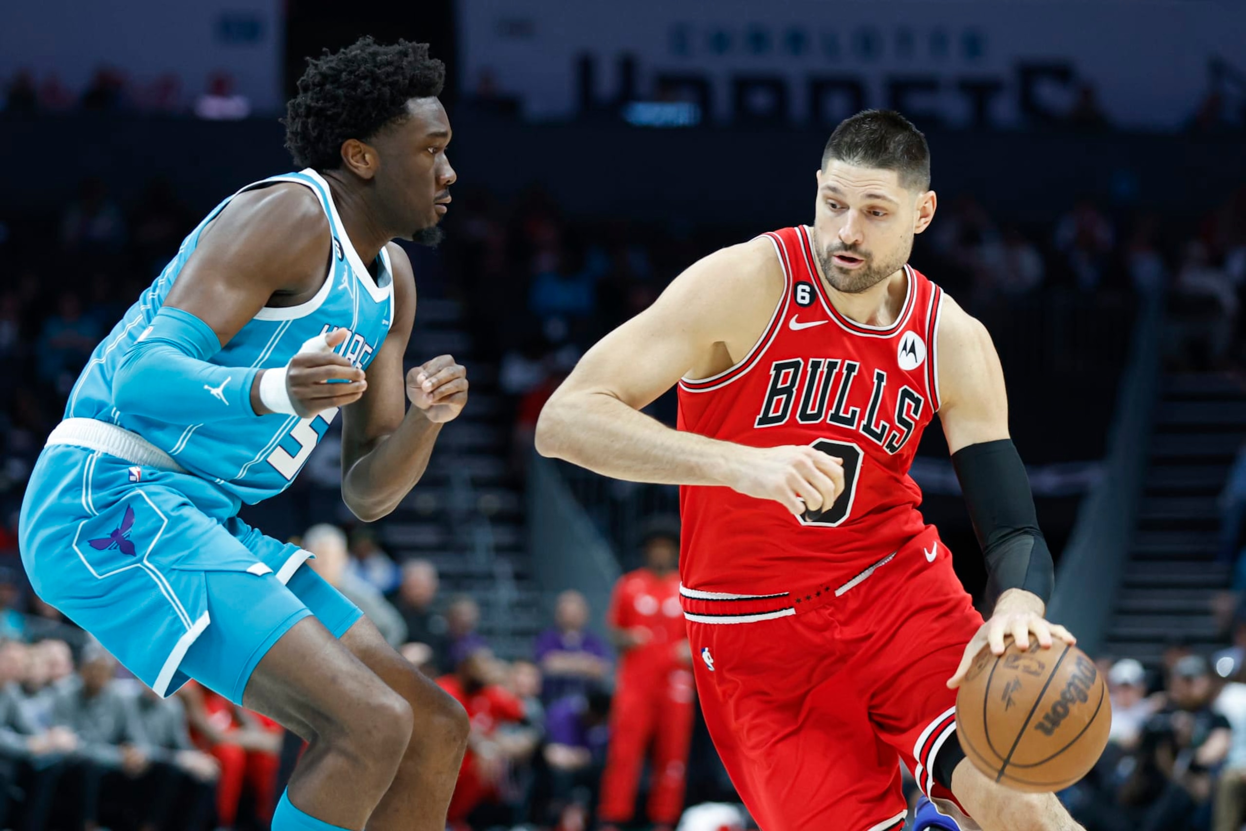 Chicago Bulls center Nikola Vucevic, right, drives against Charlotte Hornets center Mark Williams during the first half of an NBA basketball game in Charlotte, N.C., Friday, March 31, 2023. (AP Photo/Nell Redmond)