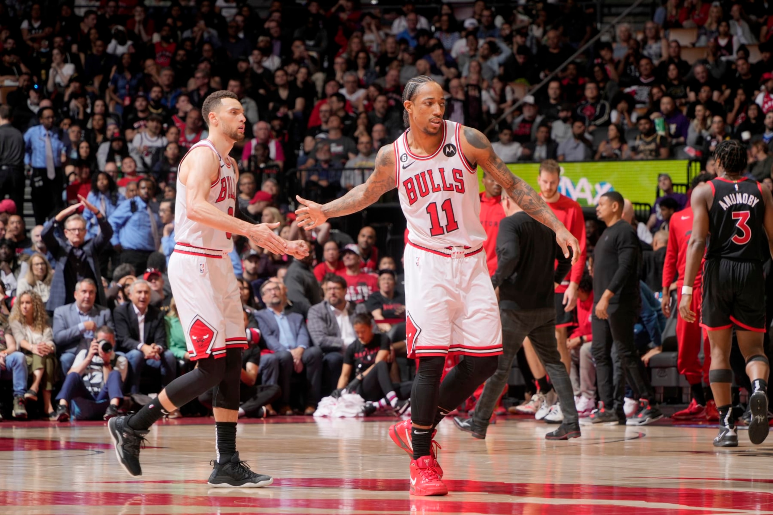 TORONTO, CANADA - APRIL 12:  DeMar DeRozan #11 high fives Zach LaVine #8 of the Chicago Bulls during the game against the Toronto Raptors during the 2023 Play-In Tournament on April 12, 2023 at the Scotiabank Arena in Toronto, Ontario, Canada.  NOTE TO USER: User expressly acknowledges and agrees that, by downloading and or using this Photograph, user is consenting to the terms and conditions of the Getty Images License Agreement.  Mandatory Copyright Notice: Copyright 2022 NBAE (Photo by Mark Blinch/NBAE via Getty Images)