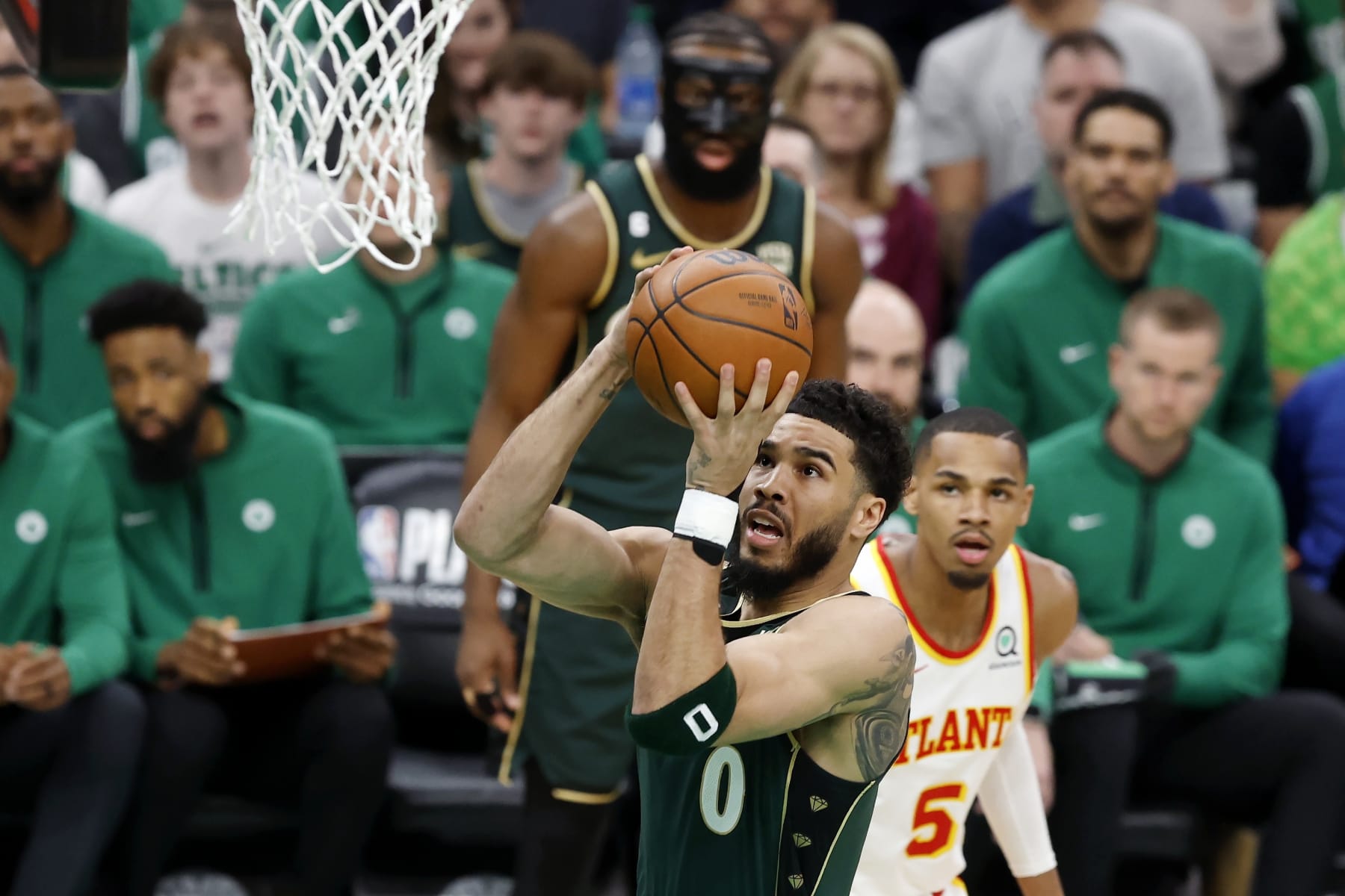 Boston Celtics' Jayson Tatum (0) shoots in front of Atlanta Hawks' Dejounte Murray (5) in the first half during Game 1 in the first round of the NBA basketball playoffs, Saturday, April 15, 2023, in Boston. (AP Photo/Michael Dwyer)