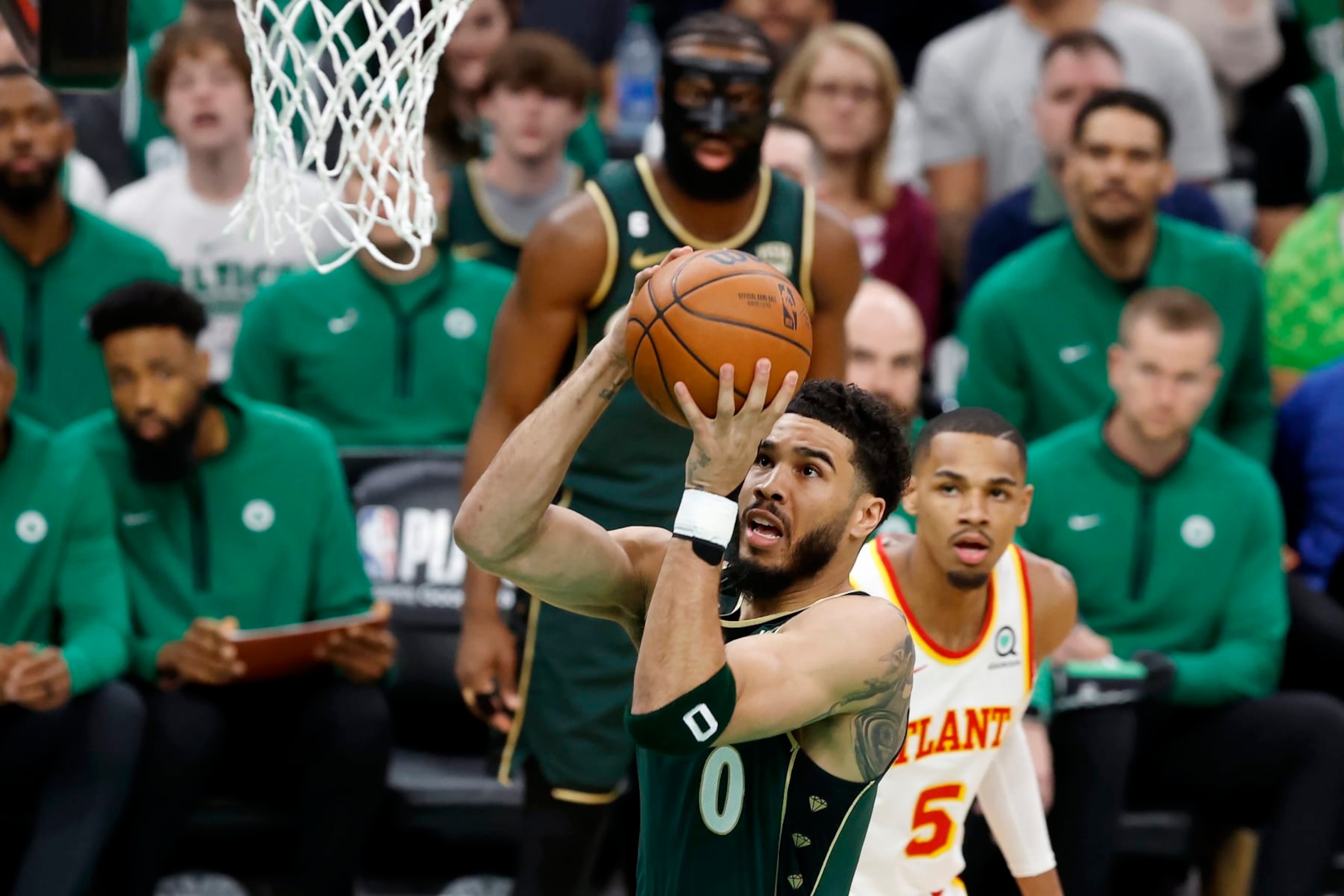 Boston Celtics' Jayson Tatum (0) shoots in front of Atlanta Hawks' Dejounte Murray (5) in the first half during Game 1 in the first round of the NBA basketball playoffs, Saturday, April 15, 2023, in Boston. (AP Photo/Michael Dwyer) Boston Celtics' Jayson Tatum (0) shoots in front of Atlanta Hawks' Dejounte Murray (5) in the first half during Game 1 in the first round of the NBA basketball playoffs, Saturday, April 15, 2023, in Boston. (AP Photo/Michael Dwyer)