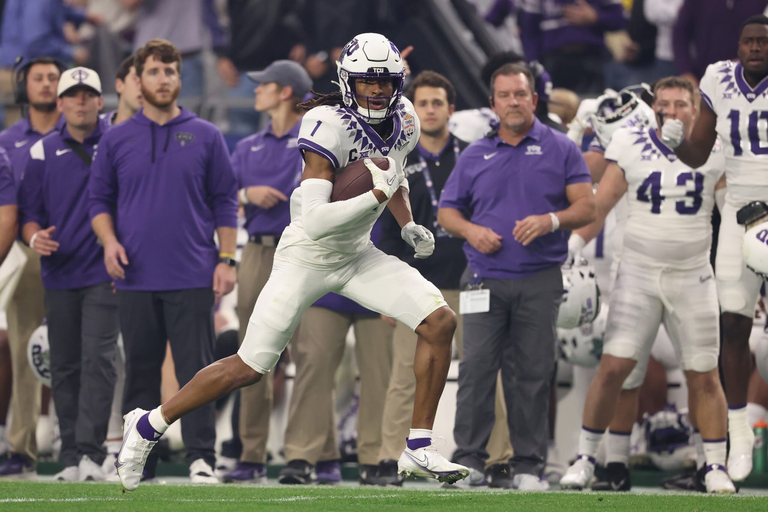 GLENDALE, ARIZONA - DECEMBER 31: Wide receiver Quentin Johnston #1 of the TCU Horned Frogs runs with the football during the fourth quarter of the Vrbo Fiesta Bowl at State Farm Stadium on December 31, 2022 in Glendale, Arizona. The Horned Frogs defeated the Wolverines 51-45.  (Photo by Christian Petersen/Getty Images)