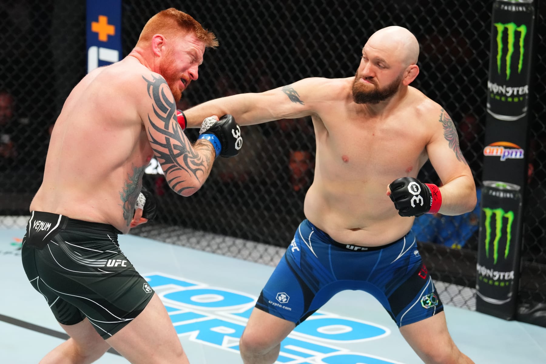 KANSAS CITY, MISSOURI - APRIL 15: (R-L) Zak Cummings punches Ed Herman in a light heavyweight fight during the UFC Fight Night event at T-Mobile Center on April 15, 2023 in Kansas City, Missouri. (Photo by Josh Hedges/Zuffa LLC via Getty Images)