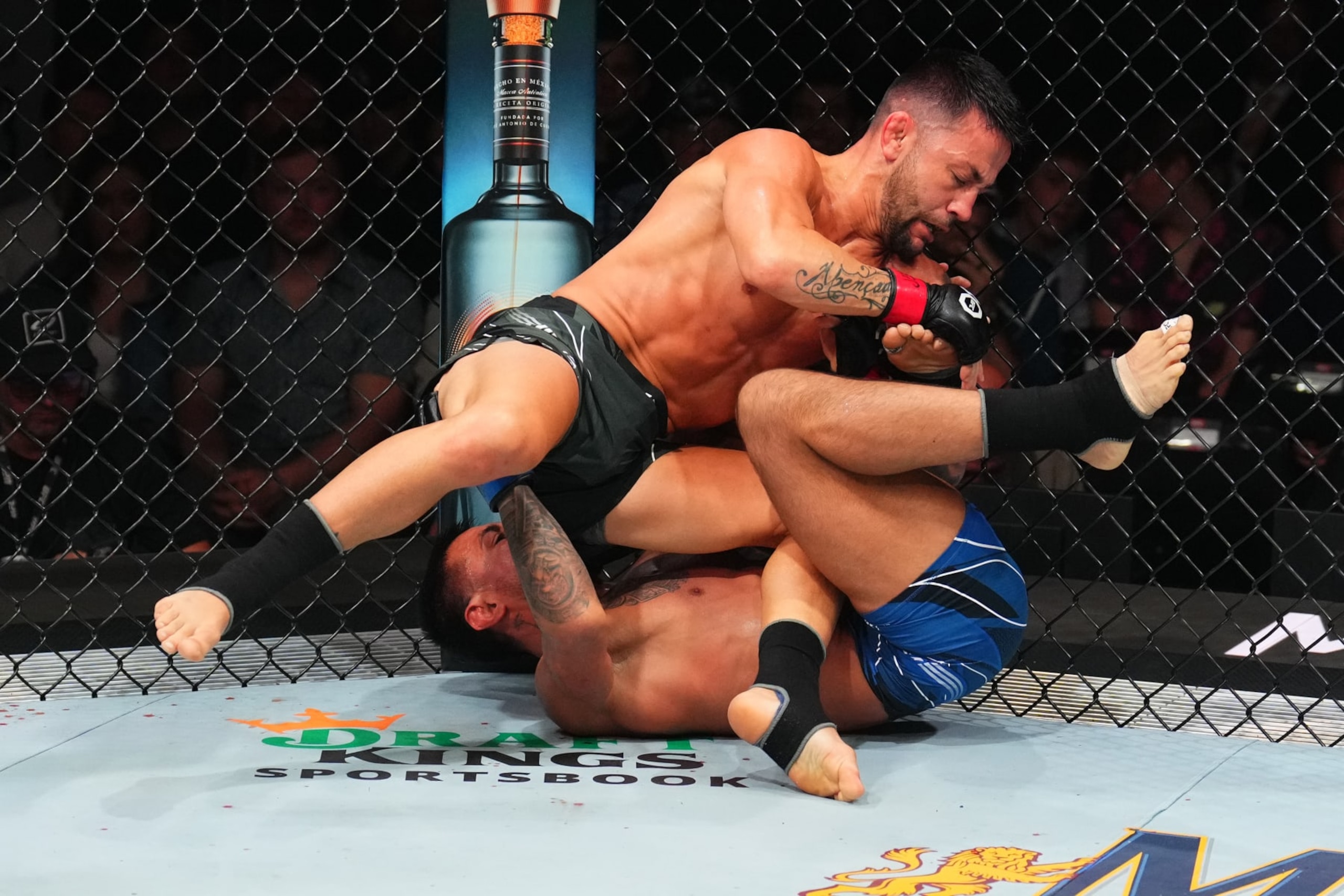 KANSAS CITY, MISSOURI - APRIL 15: (L-R) Pedro Munhoz of Brazil controls the body of Chris Gutierrez in a bantamweight fight during the UFC Fight Night event at T-Mobile Center on April 15, 2023 in Kansas City, Missouri. (Photo by Josh Hedges/Zuffa LLC via Getty Images)