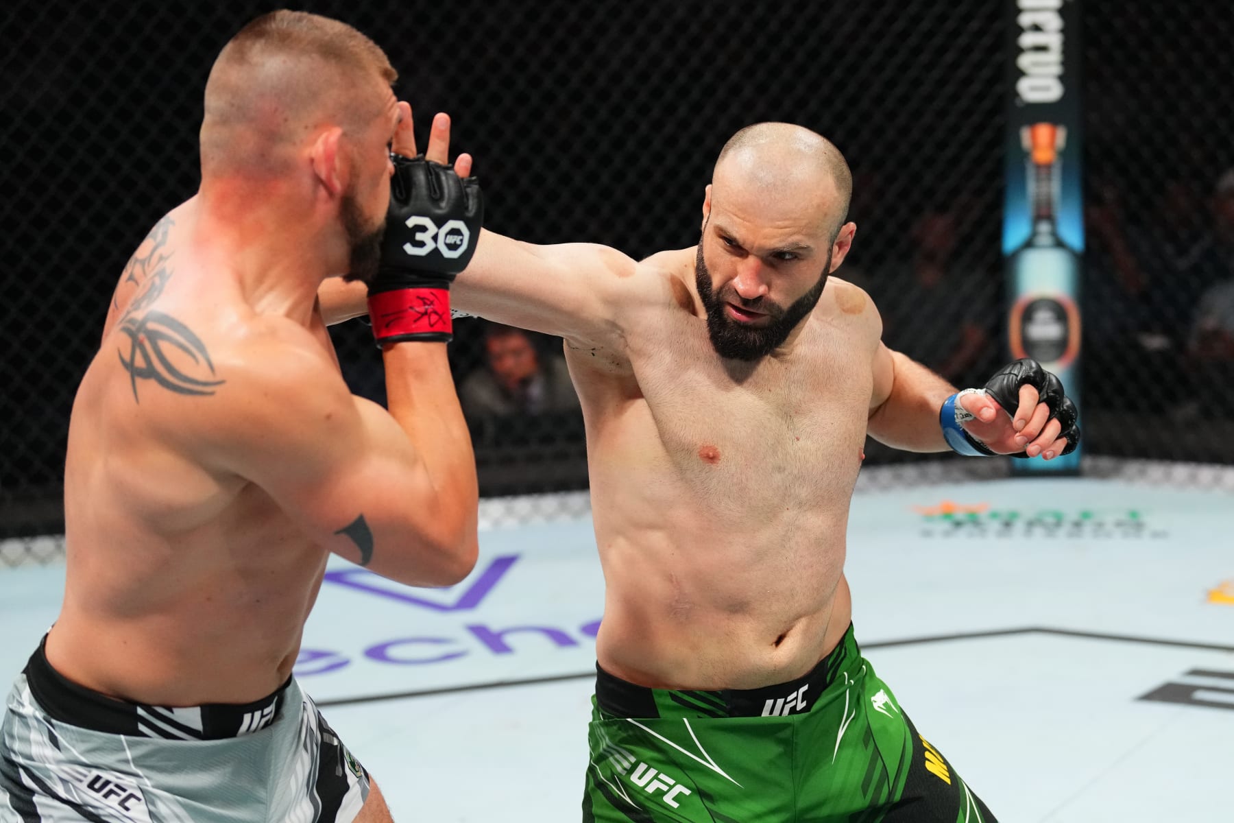 KANSAS CITY, MISSOURI - APRIL 15: (R-L) Azamat Murzakanov of Russia punches Dustin Jacoby in a light heavyweight fight during the UFC Fight Night event at T-Mobile Center on April 15, 2023 in Kansas City, Missouri. (Photo by Josh Hedges/Zuffa LLC via Getty Images)