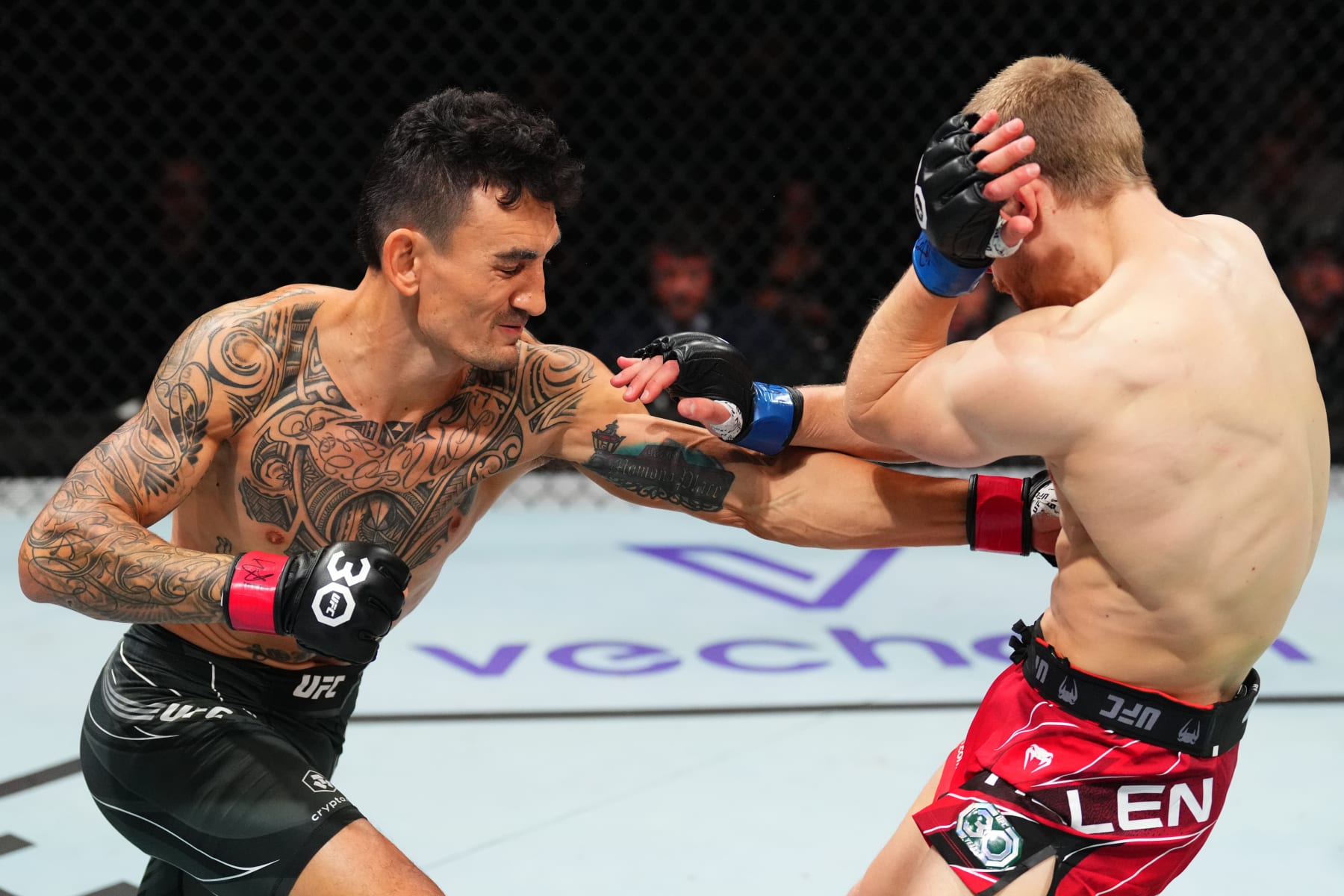 KANSAS CITY, MISSOURI - APRIL 15: (L-R) Max Holloway punches Arnold Allen of England in a featherweight fight during the UFC Fight Night event at T-Mobile Center on April 15, 2023 in Kansas City, Missouri. (Photo by Josh Hedges/Zuffa LLC via Getty Images)