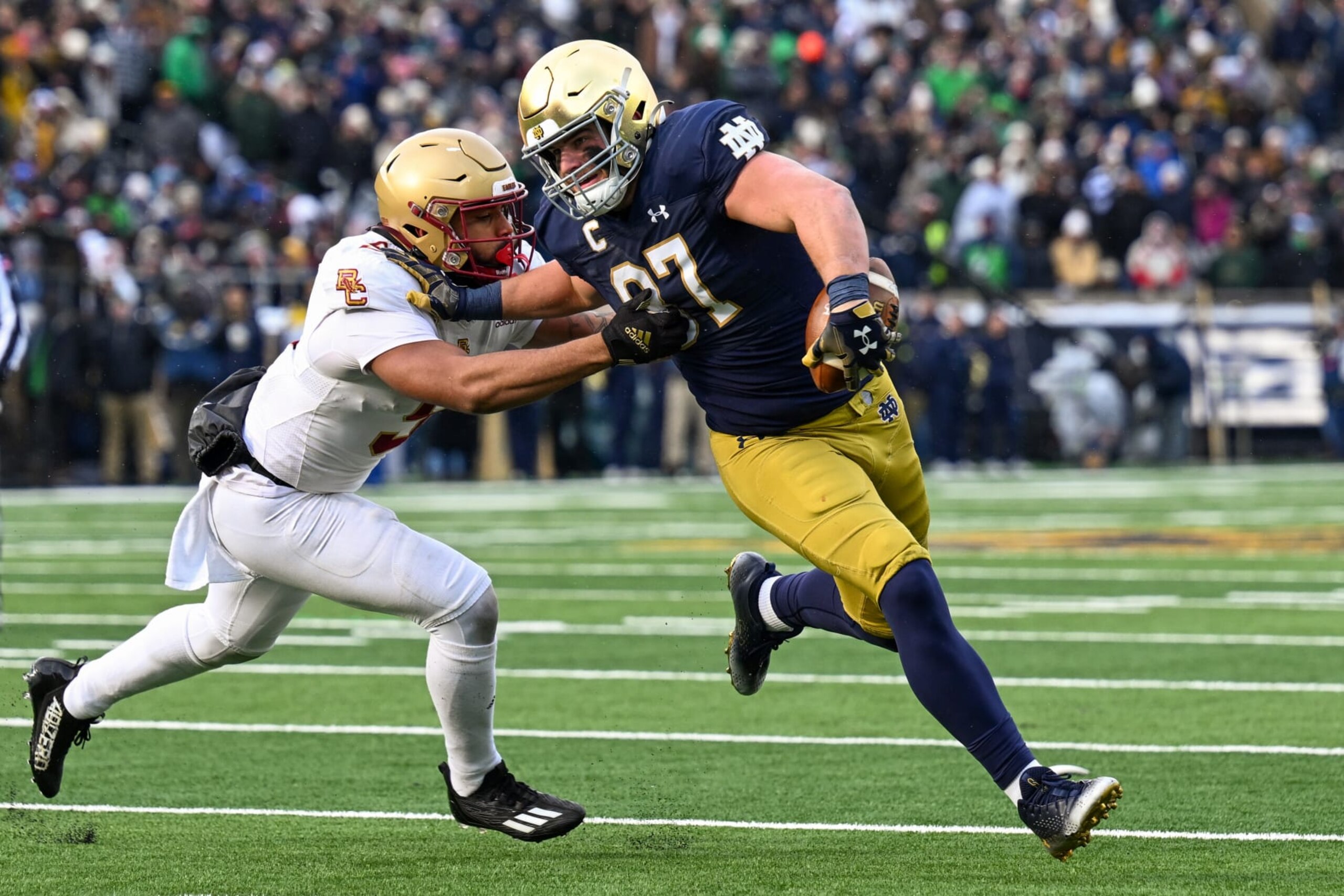 SOUTH BEND, INDIANA - NOVEMBER 19: Michael Mayer #87 of the Notre Dame Fighting Irish runs for a first down in the first half against Jaiden Woodbey #9 of the Boston College Eagles at Notre Dame Stadium on November 19, 2022 in South Bend, Indiana. (Photo by Quinn Harris/Getty Images)