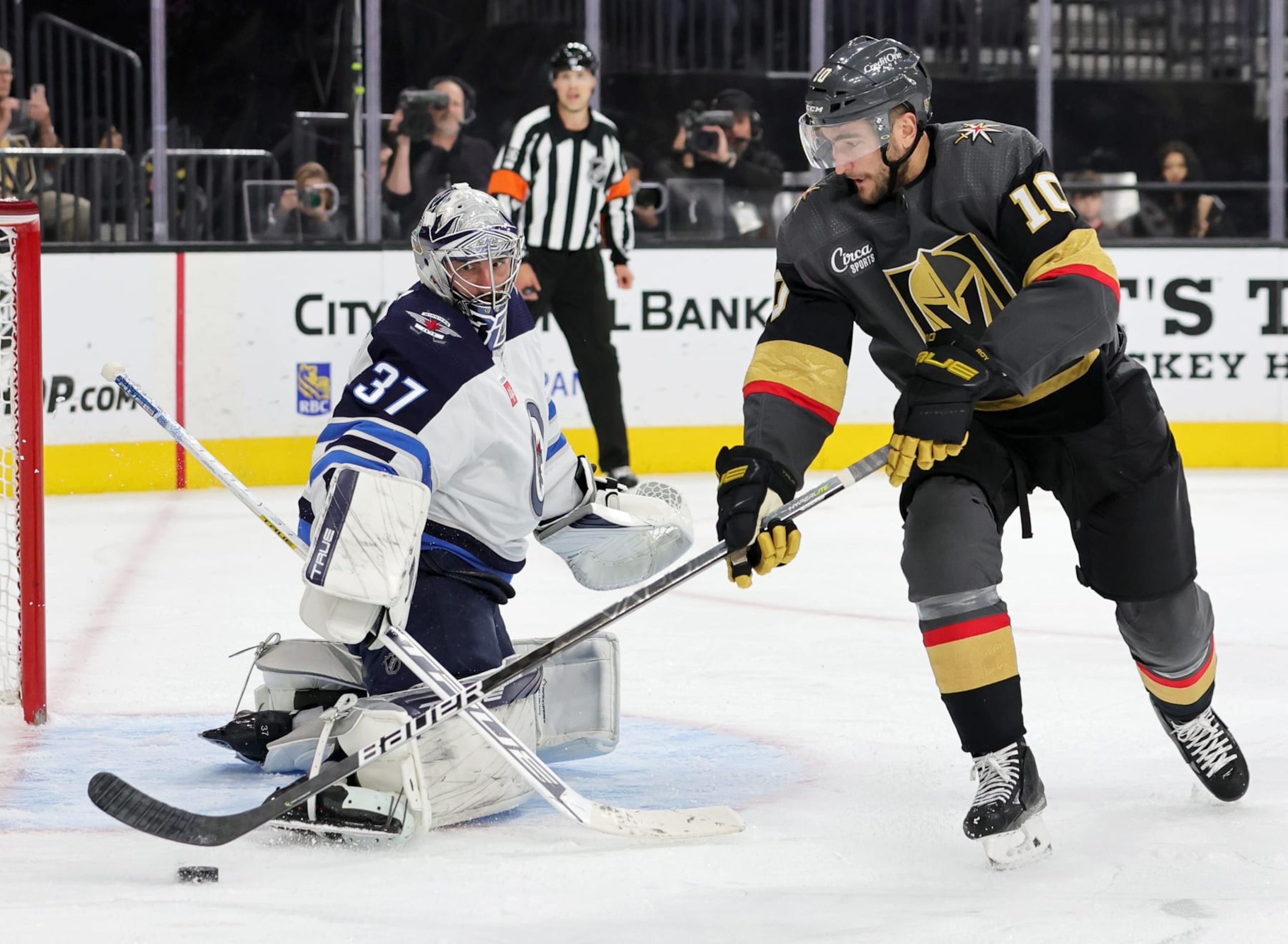 LAS VEGAS, NEVADA - OCTOBER 30: Connor Hellebuyck #37 of the Winnipeg Jets defends the net against Nicolas Roy #10 of the Vegas Golden Knights in the second period of their game at T-Mobile Arena on October 30, 2022 in Las Vegas, Nevada. (Photo by Ethan Miller/Getty Images)