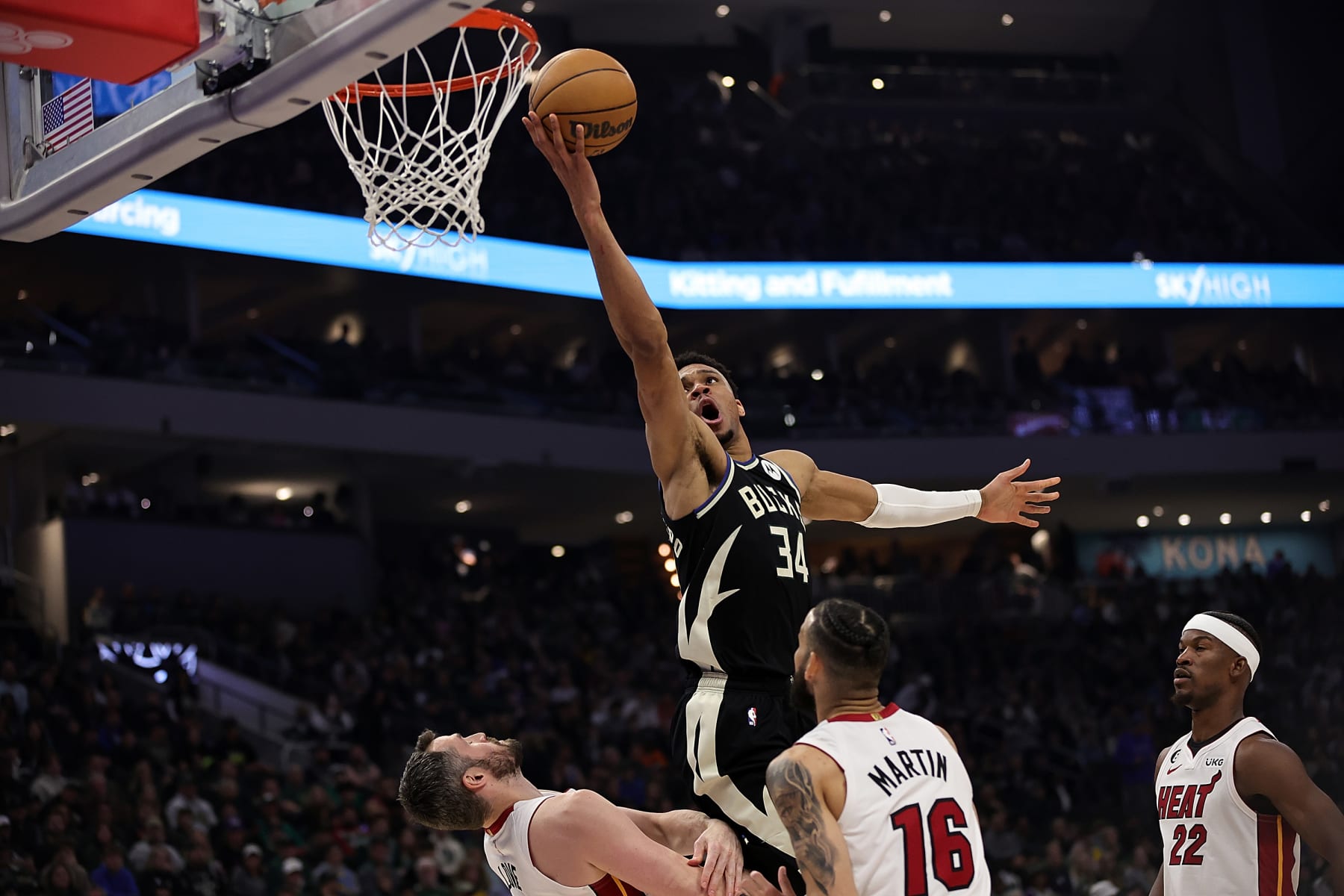 MILWAUKEE, WISCONSIN - APRIL 16: Giannis Antetokounmpo #34 of the Milwaukee Bucks is fouled by Kevin Love #42 of the Miami Heat during the first half of Game One of the Eastern Conference First Round Playoffs at Fiserv Forum on April 16, 2023 in Milwaukee, Wisconsin. NOTE TO USER: User expressly acknowledges and agrees that, by downloading and or using this photograph, User is consenting to the terms and conditions of the Getty Images License Agreement. (Photo by Stacy Revere/Getty Images)