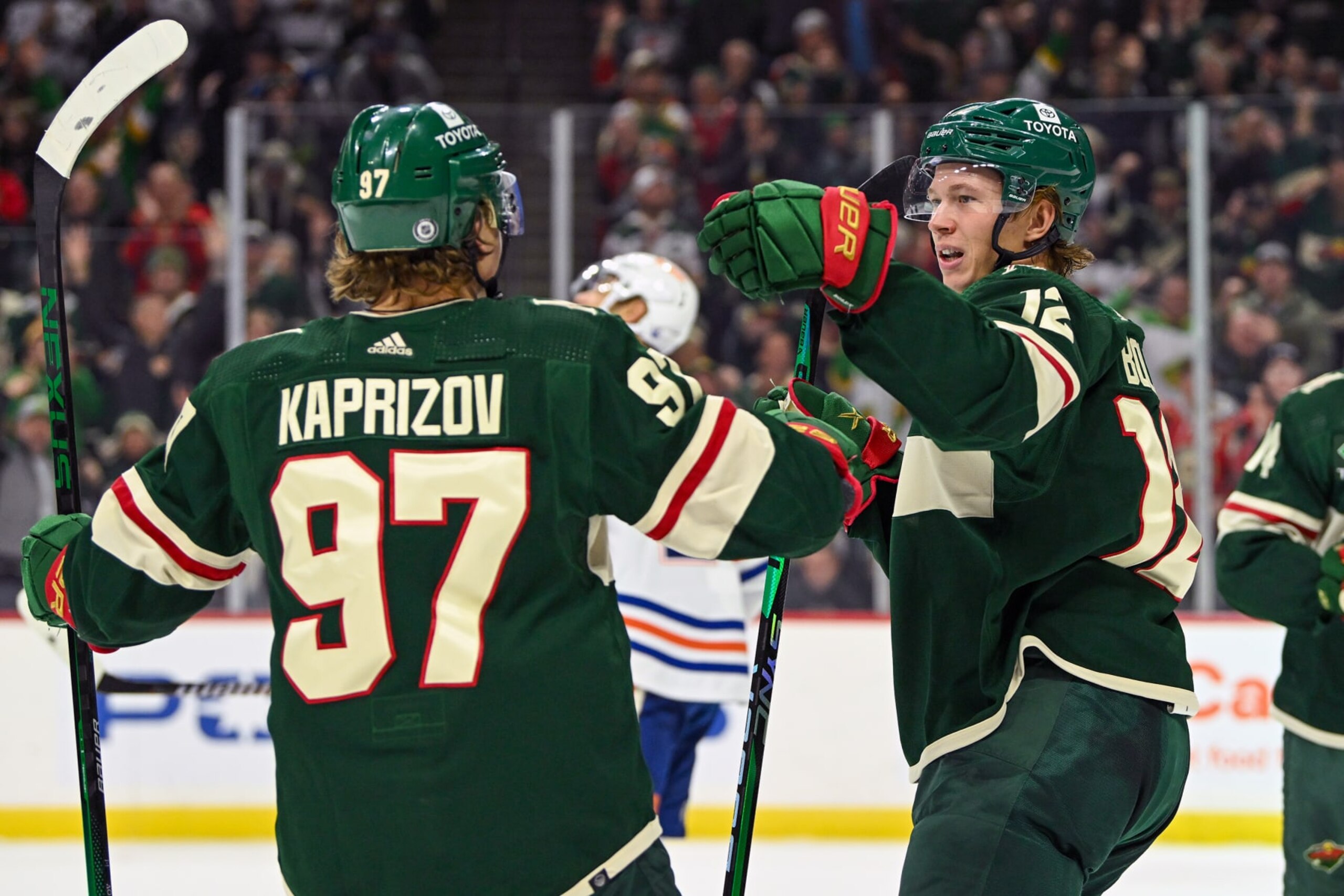 ST. PAUL, MN - DECEMBER 12: Minnesota Wild Right Wing Matt Boldy (12) celebrates his power play goal with Minnesota Wild Left Wing Kirill Kaprizov (97) who assisted on the tally during the first period of a game between the Minnesota Wild and Edmonton Oilers on December 12, 2022, at Xcel Energy Center in St. Paul, MN.(Photo by Nick Wosika/Icon Sportswire via Getty Images)