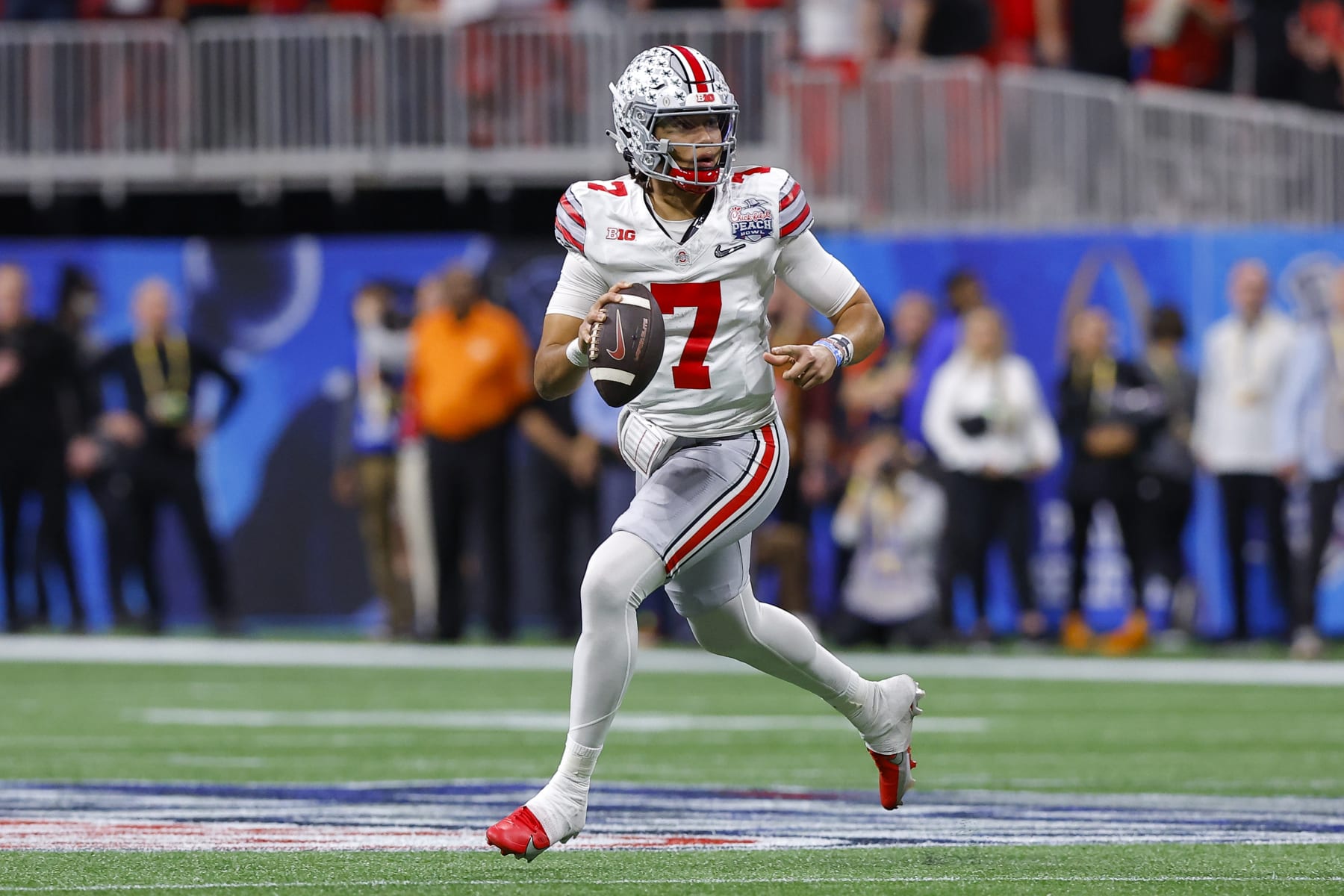 ATLANTA, GA - DECEMBER 31: C.J. Stroud #7 of the Ohio State Buckeyes rolls out in the first half against the Georgia Bulldogs in the Chick-fil-A Peach Bowl at Mercedes-Benz Stadium on December 31, 2022 in Atlanta, Georgia. (Photo by Todd Kirkland/Getty Images)
