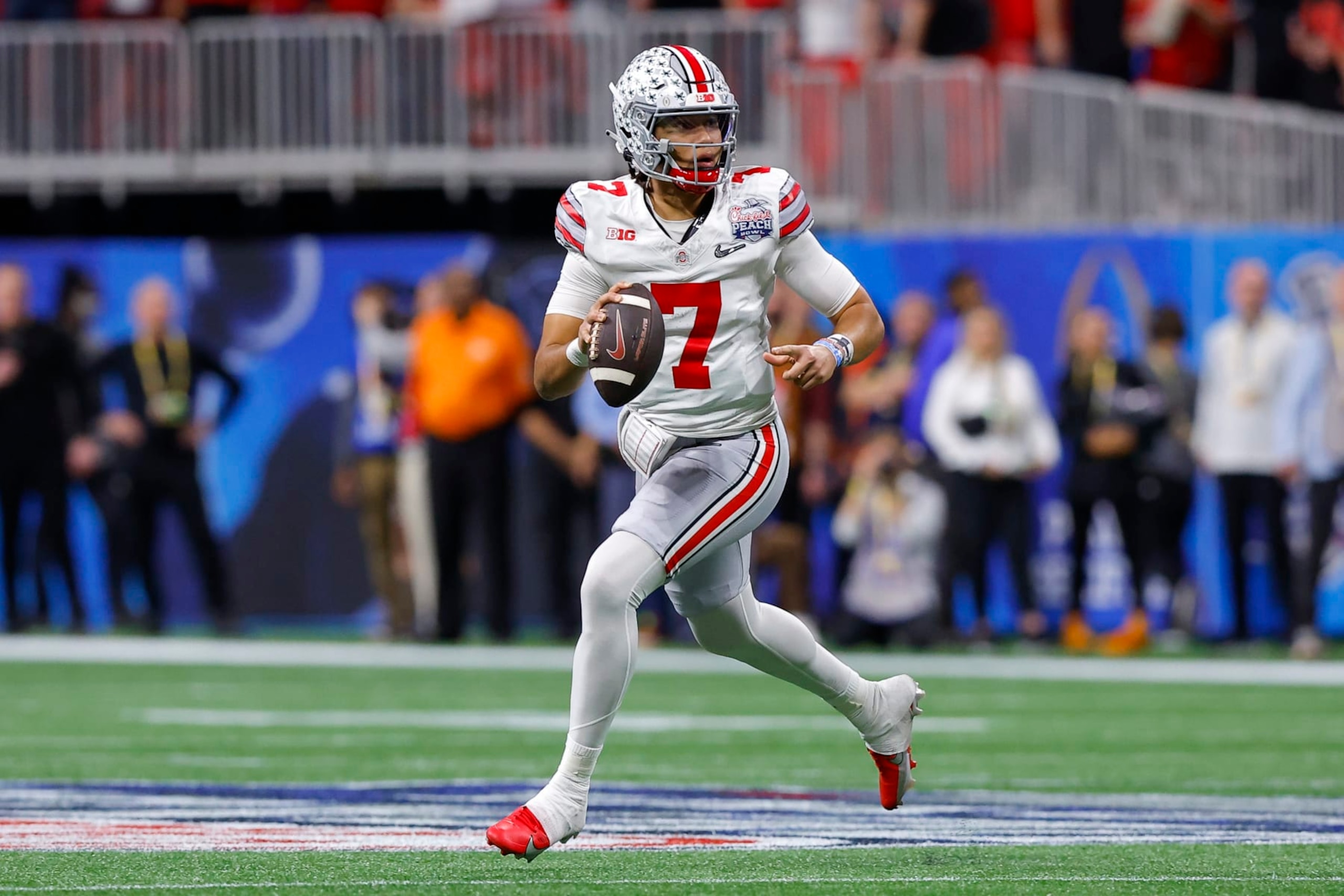 ATLANTA, GA - DECEMBER 31: C.J. Stroud #7 of the Ohio State Buckeyes rolls out in the first half against the Georgia Bulldogs in the Chick-fil-A Peach Bowl at Mercedes-Benz Stadium on December 31, 2022 in Atlanta, Georgia. (Photo by Todd Kirkland/Getty Images)