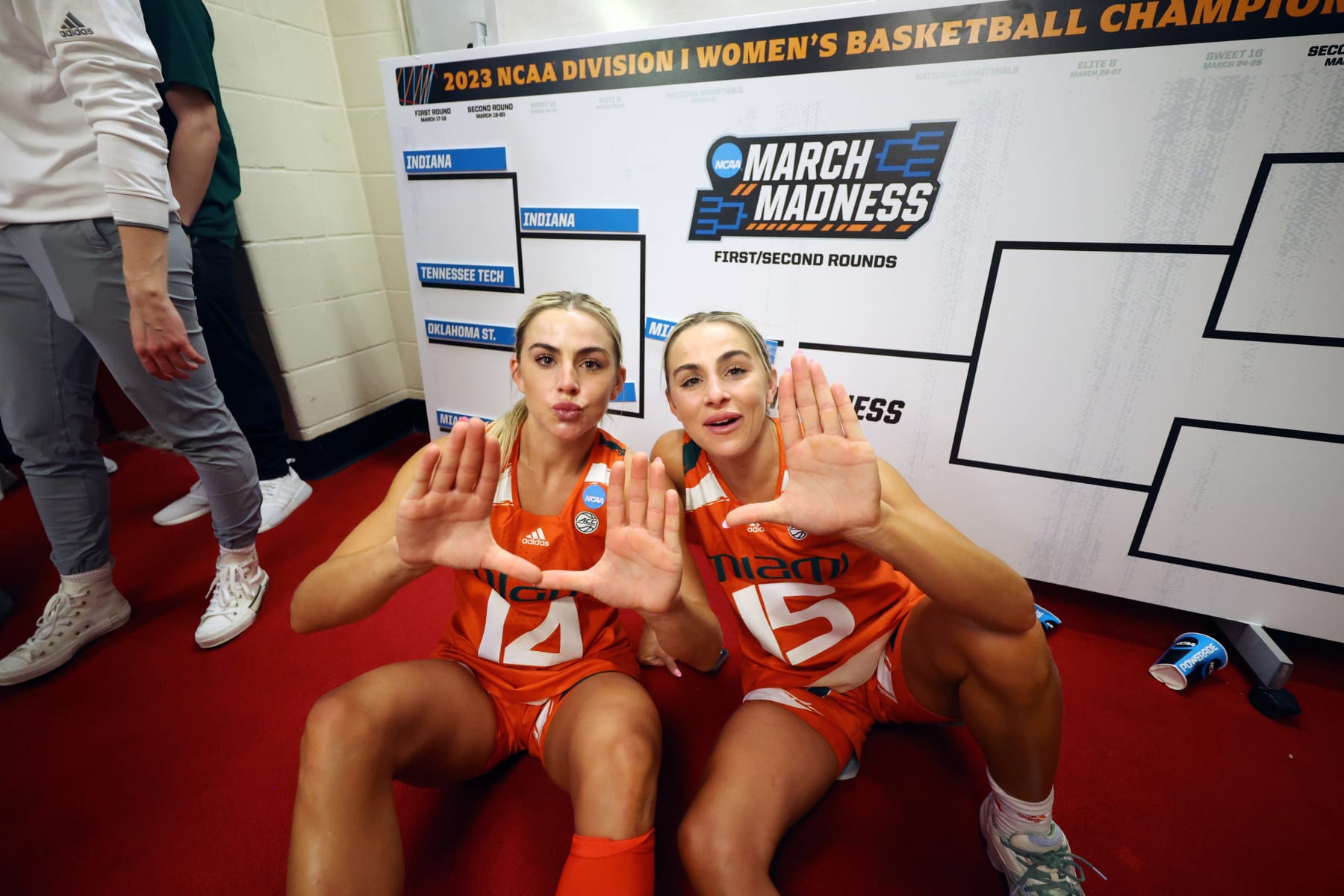 BLOOMINGTON, IN - MARCH 20: Haley Cavinder #14 and Hanna Cavinder #15 of the Miami Hurricanes celebrate in the locker room after defeating the Indiana Hoosiers during the second round of the 2023 NCAA Women's Basketball Tournament held at Simon Skjodt Assembly Hall on March 20, 2023 in Bloomington, Indiana. (Photo by Joe Robbins/NCAA Photos via Getty Images)